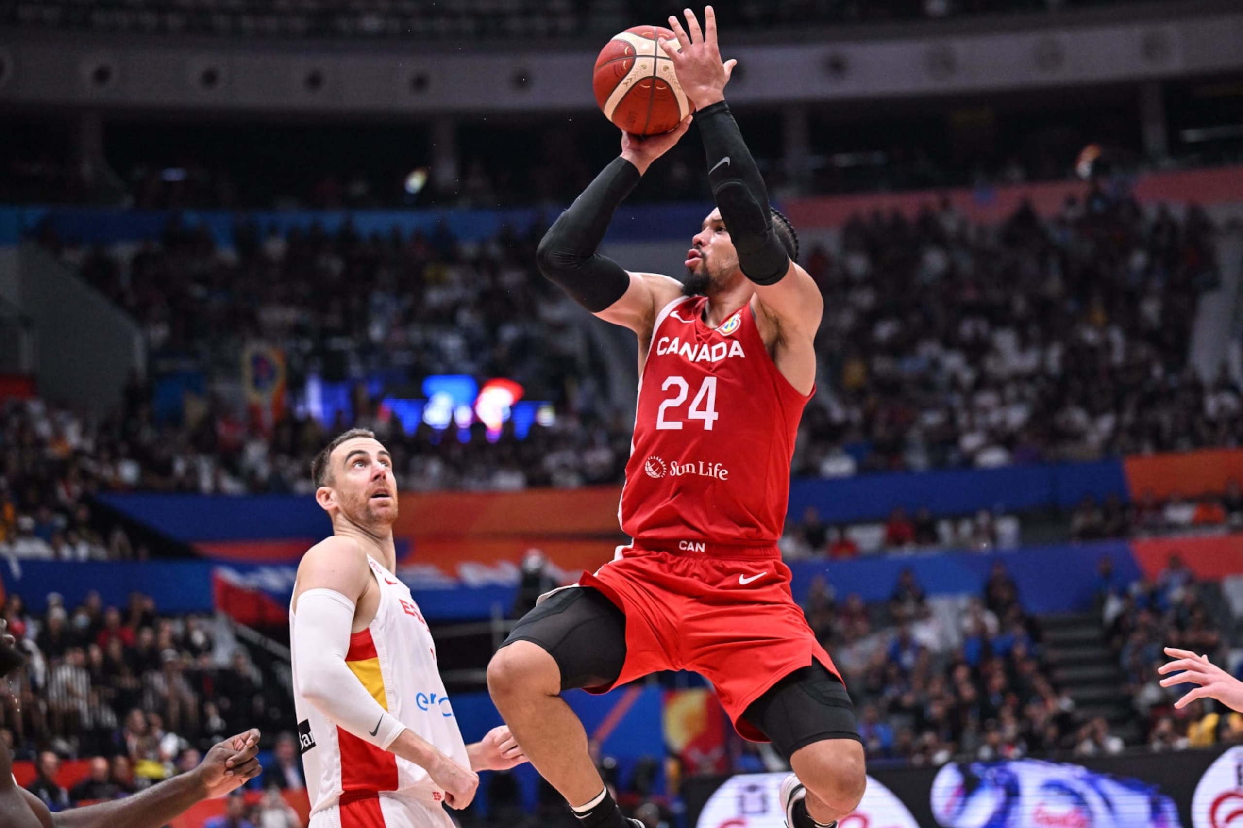 Canada's Dillon Brooks shoots as Victor Claver looks on during the FIBA Basketball World Cup match between Spain and Canada at Indonesia Arena in Jakarta on September 3, 2023. (Photo by ADEK BERRY / AFP) (Photo by ADEK BERRY/AFP via Getty Images)