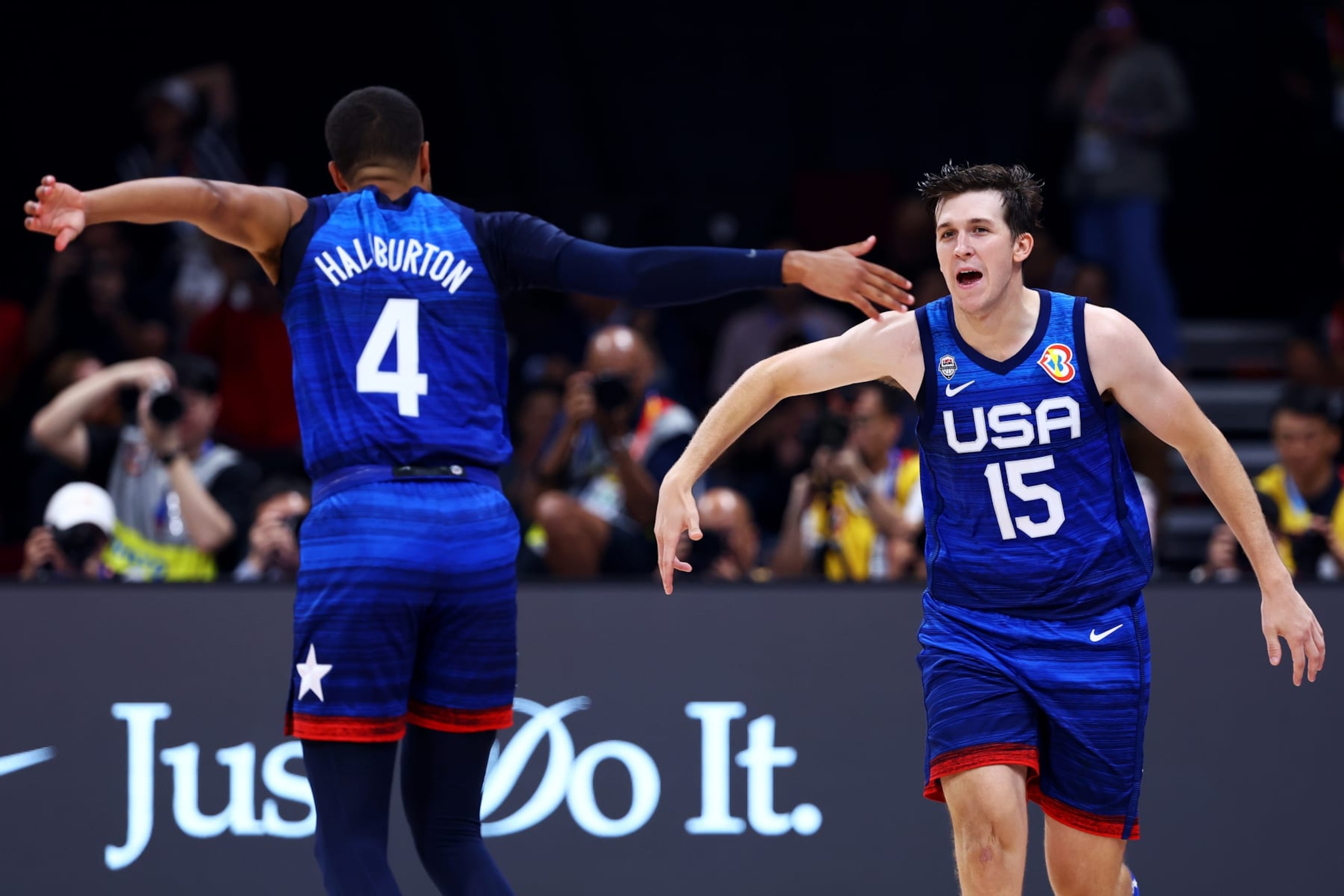 MANILA, PHILIPPINES - SEPTEMBER 05: Austin Reaves #15 (R) of the United States celebrates with Tyrese Haliburton #4 after scoring a three-pointer in the third quarter during the FIBA Basketball World Cup quarterfinal game against Italy at Mall of Asia Arena on September 05, 2023 in Manila, Philippines. (Photo by Yong Teck Lim/Getty Images)