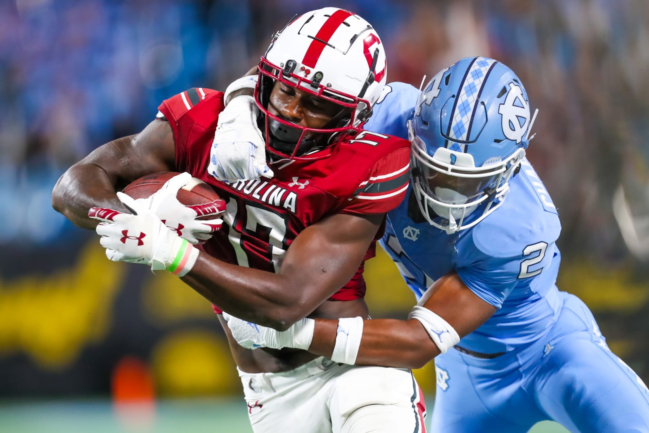 CHARLOTTE, NC - SEPTEMBER 02: Don Chapman #2 of the North Carolina Tar Heels attempts to tackle Xavier Legette #17 of the South Carolina Gamecocks as he runs the ball during a football game at Bank of America Stadium in Charlotte, North Carolina, on Sep 2, 2023.  (Photo by David Jensen/Icon Sportswire via Getty Images)