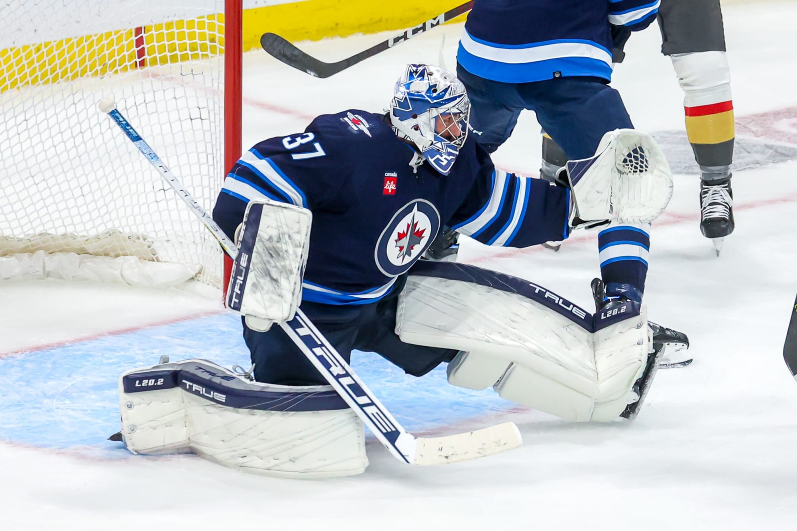 WINNIPEG, CANADA - APRIL 22: Goaltender Connor Hellebuyck #37 of the Winnipeg Jets reacts to a shot during action in the first overtime period against the Vegas Golden Knights in Game Three of the First Round of the 2023 Stanley Cup Playoffs at Canada Life Centre on April 22, 2023 in Winnipeg, Manitoba, Canada. (Photo by Jonathan Kozub/NHLI via Getty Images) WINNIPEG, CANADA - APRIL 22: Goaltender Connor Hellebuyck #37 of the Winnipeg Jets reacts to a shot during action in the first overtime period against the Vegas Golden Knights in Game Three of the First Round of the 2023 Stanley Cup Playoffs at Canada Life Centre on April 22, 2023 in Winnipeg, Manitoba, Canada. (Photo by Jonathan Kozub/NHLI via Getty Images)