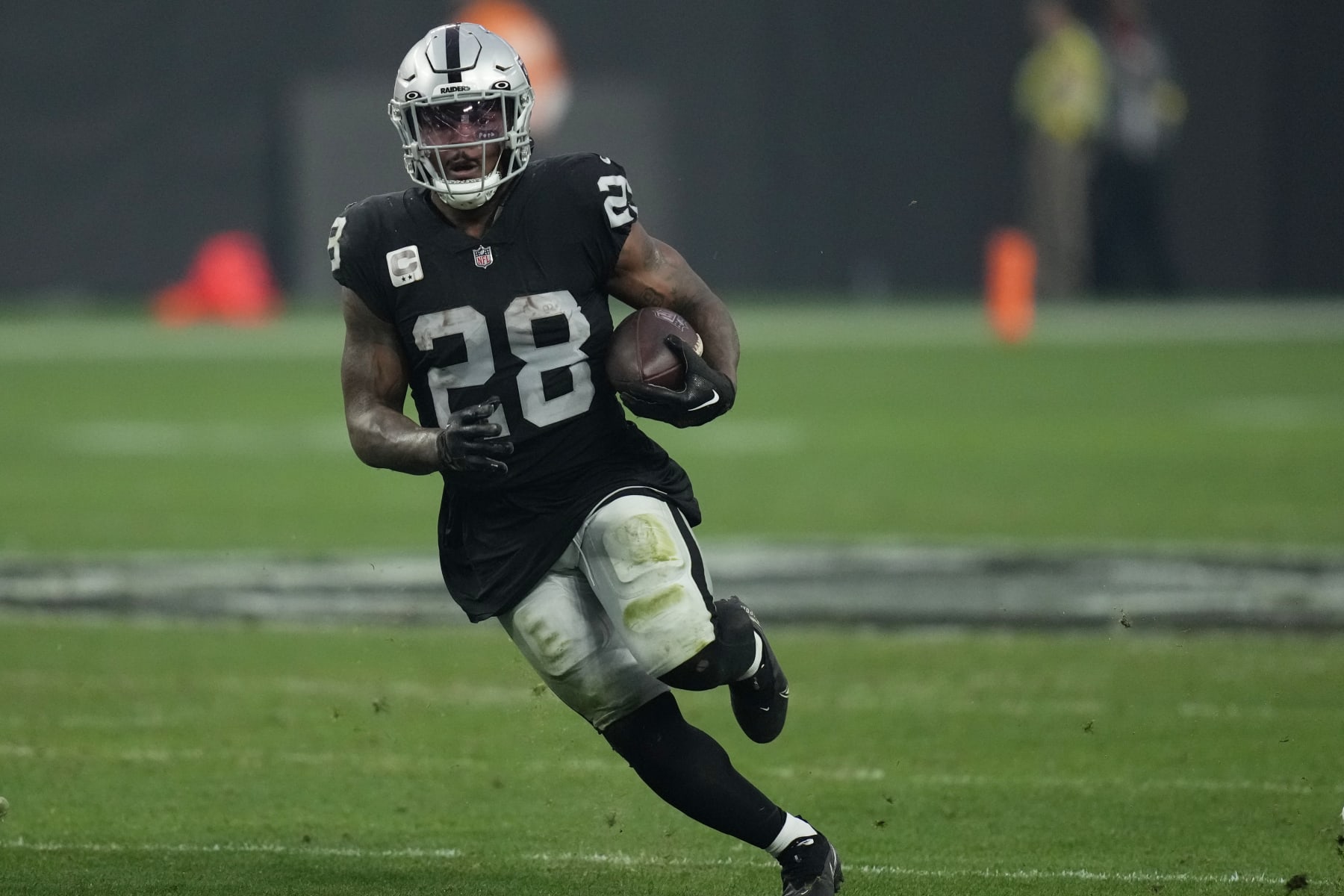 Las Vegas Raiders running back Josh Jacobs (28) runs against the Kansas City Chiefs during the second half of an NFL football game, Wednesday, Jan. 11, 2023, in Las Vegas. (AP Photo/John Locher)