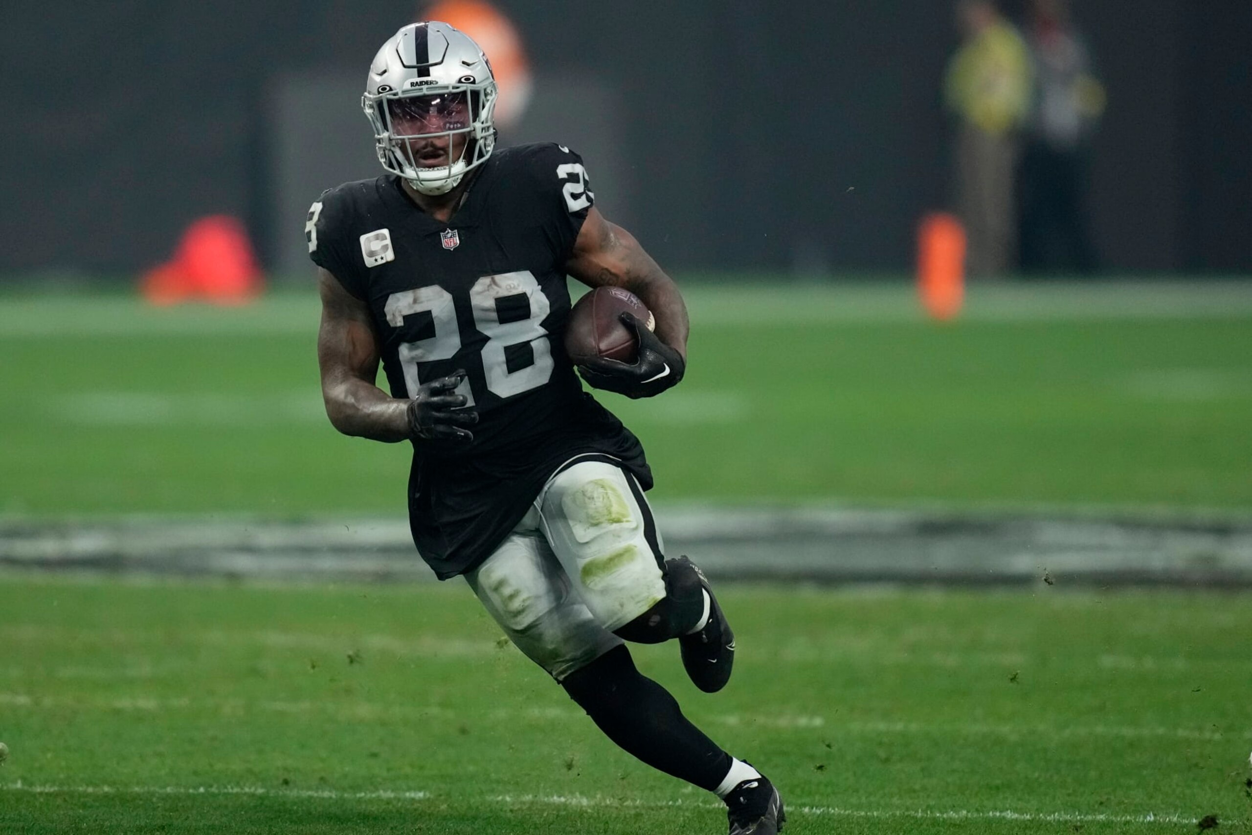Las Vegas Raiders running back Josh Jacobs (28) runs against the Kansas City Chiefs during the second half of an NFL football game, Wednesday, Jan. 11, 2023, in Las Vegas. (AP Photo/John Locher) Las Vegas Raiders running back Josh Jacobs (28) runs against the Kansas City Chiefs during the second half of an NFL football game, Wednesday, Jan. 11, 2023, in Las Vegas. (AP Photo/John Locher)