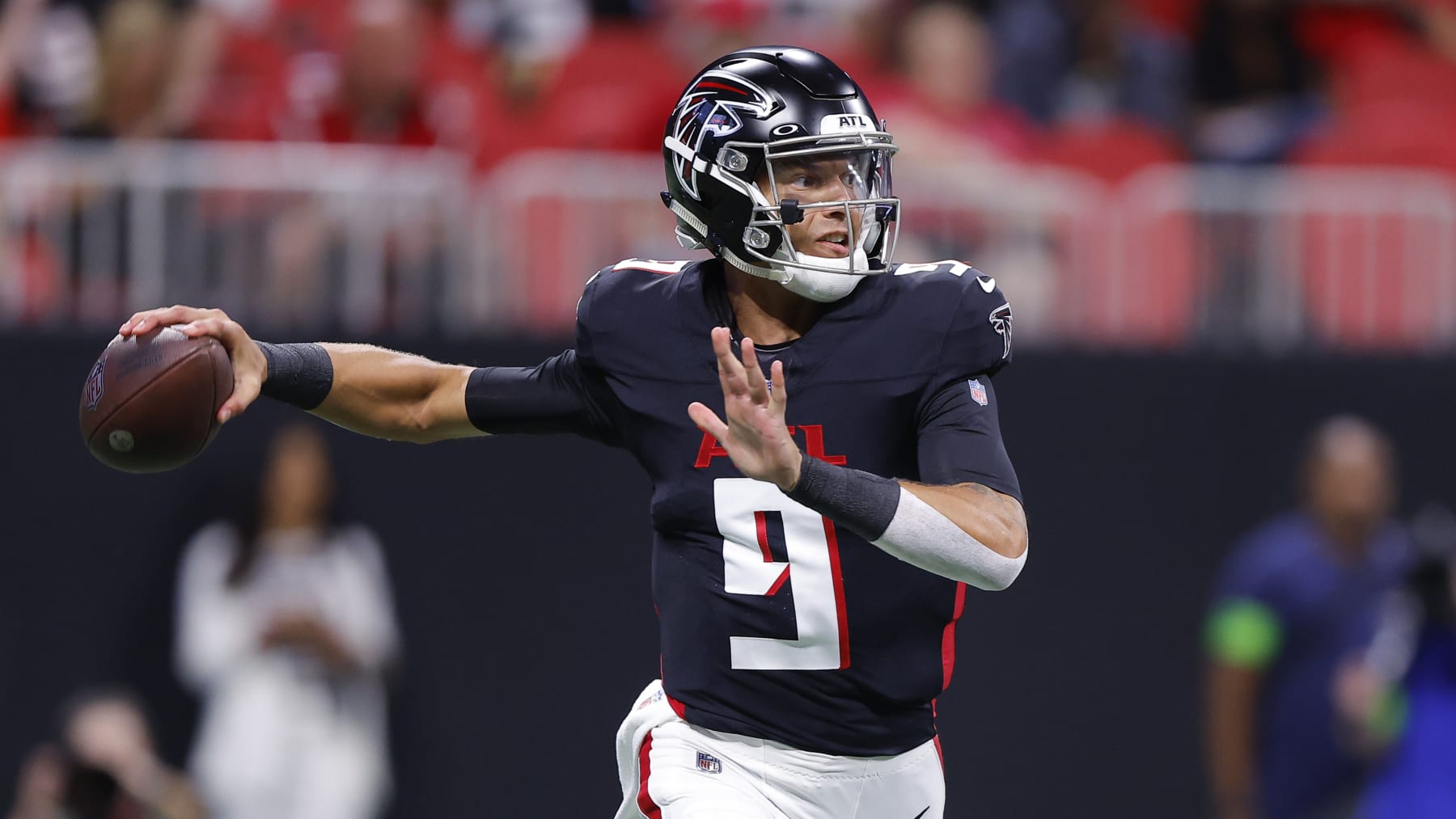 ATLANTA, GEORGIA - AUGUST 18: Desmond Ridder #9 of the Atlanta Falcons rolls out to pass during the first quarter of a preseason game against the Cincinnati Bengals at Mercedes-Benz Stadium on August 18, 2023 in Atlanta, Georgia. (Photo by Todd Kirkland/Getty Images)