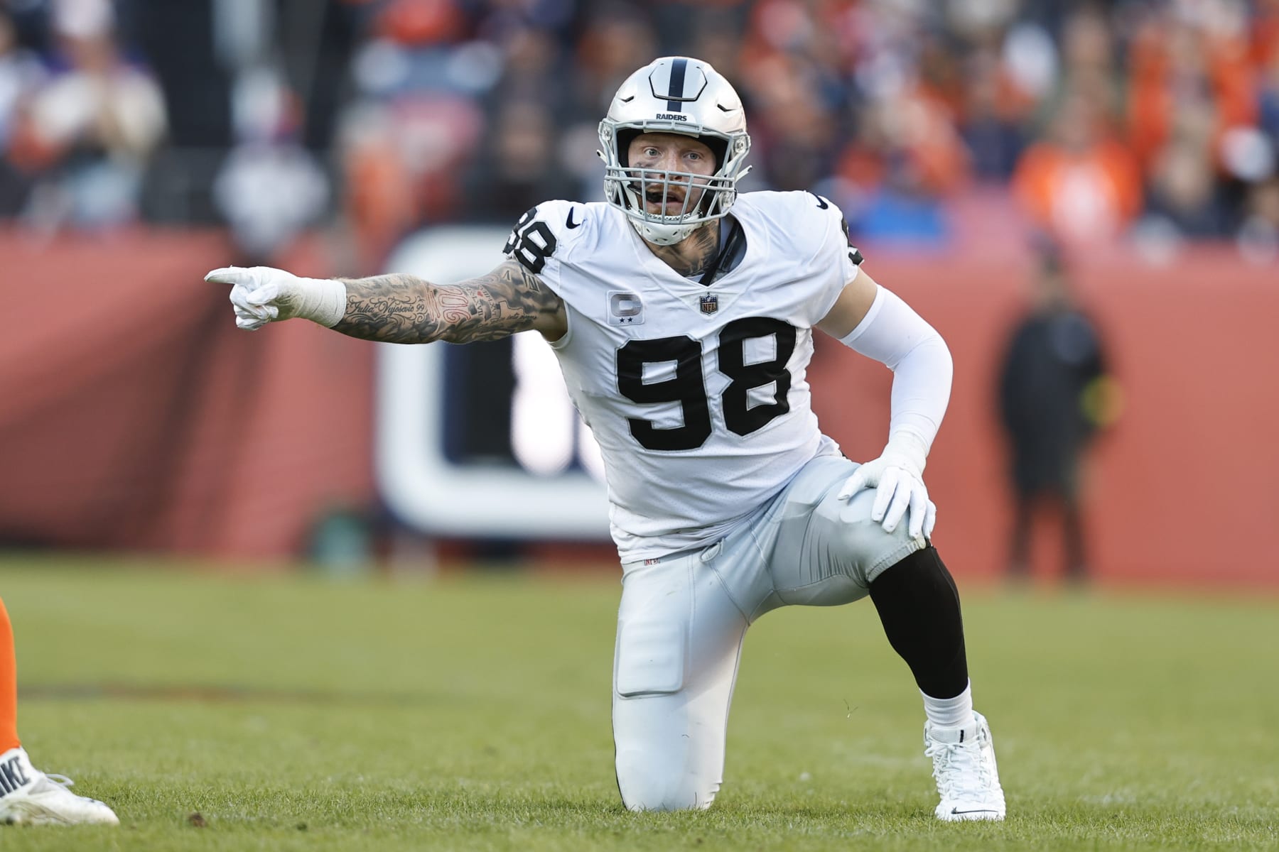 DENVER, COLORADO - NOVEMBER 20: Maxx Crosby #98 of the Las Vegas Raiders signals as he lines up during an NFL game between the Las Vegas Raiders and Denver Broncos at Empower Field At Mile High on November 20, 2022 in Denver, Colorado. (Photo by Michael Owens/Getty Images)