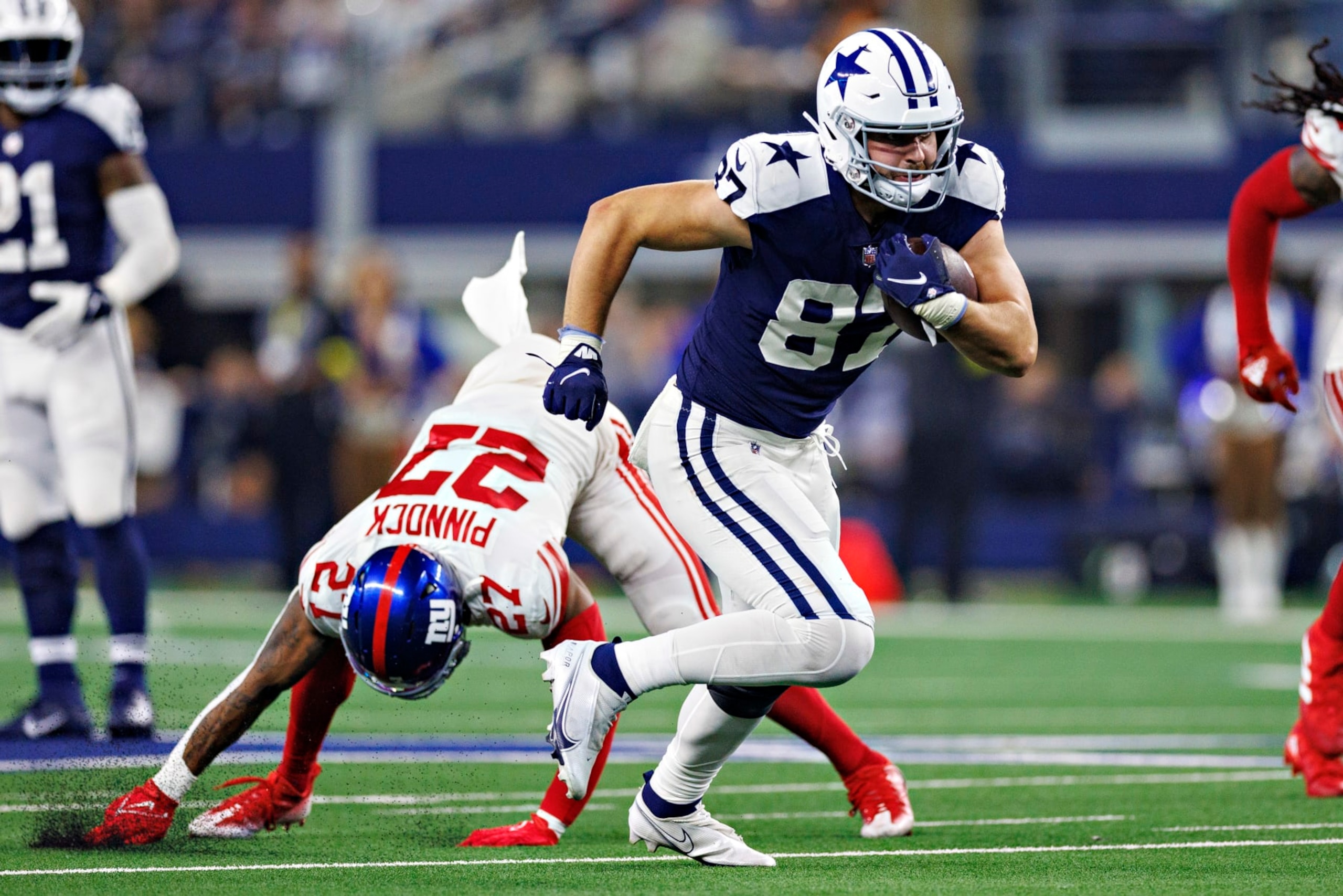 ARLINGTON, TEXAS - NOVEMBER 24:  Jake Ferguson #87 of the Dallas Cowboys runs the ball during a game against the New York Giants at AT&T Stadium on November 24, 2022 in Arlington, Texas. The Cowboys defeated the Giants 28-20. (Photo by Wesley Hitt/Getty Images)