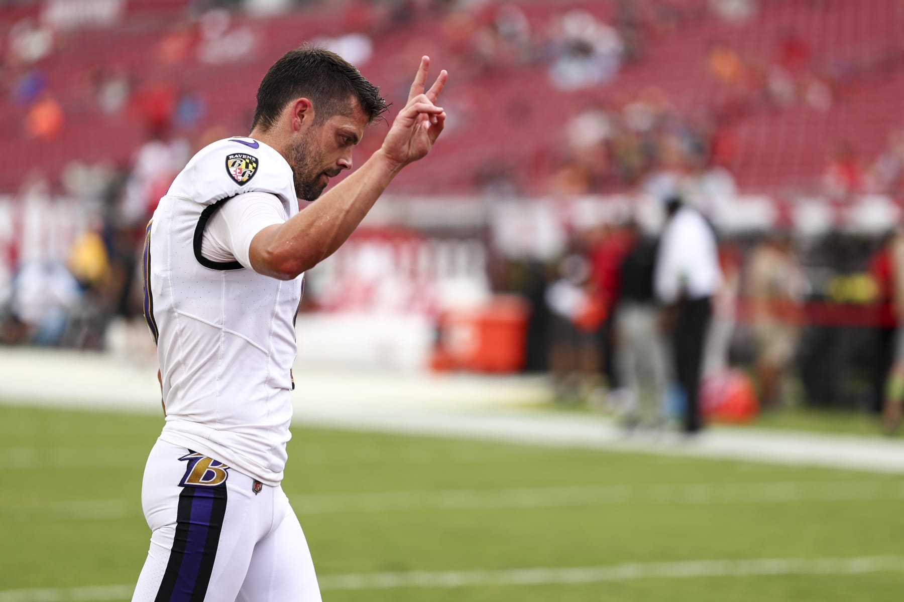 TAMPA, FL - AUGUST 26: Justin Tucker #9 of the Baltimore Ravens waves to fans prior to an NFL preseason football game against the Tampa Bay Buccaneers at Raymond James Stadium on August 26, 2023 in Tampa, Florida. (Photo by Kevin Sabitus/Getty Images)