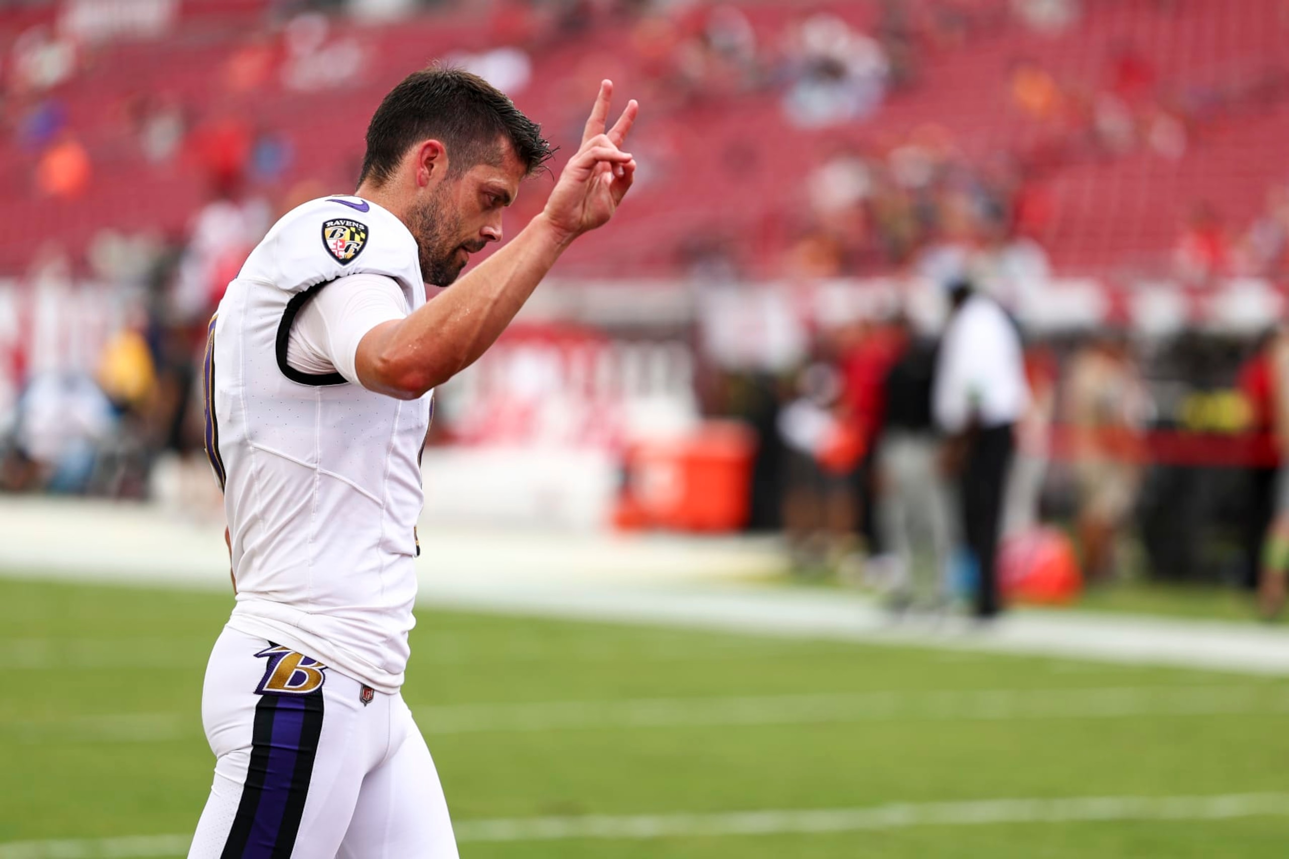 TAMPA, FL - AUGUST 26: Justin Tucker #9 of the Baltimore Ravens waves to fans prior to an NFL preseason football game against the Tampa Bay Buccaneers at Raymond James Stadium on August 26, 2023 in Tampa, Florida. (Photo by Kevin Sabitus/Getty Images)