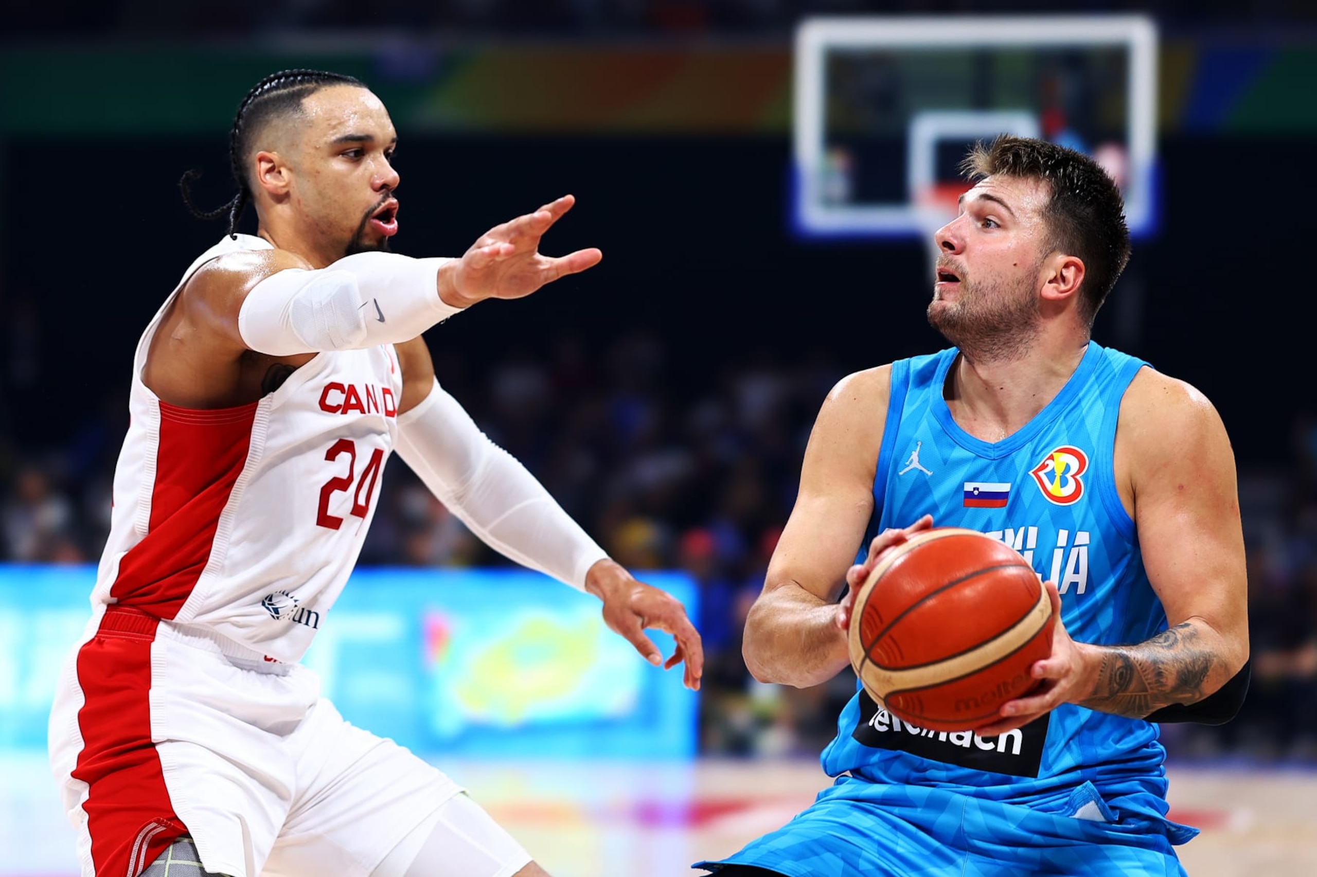 MANILA, PHILIPPINES - SEPTEMBER 06: Luka Doncic #77 of Slovenia drives against Dillon Brooks #24 of Canada in the first quarter during the FIBA Basketball World Cup quarterfinal game at Mall of Asia Arena on September 06, 2023 in Manila, Philippines. (Photo by Yong Teck Lim/Getty Images) MANILA, PHILIPPINES - SEPTEMBER 06: Luka Doncic #77 of Slovenia drives against Dillon Brooks #24 of Canada in the first quarter during the FIBA Basketball World Cup quarterfinal game at Mall of Asia Arena on September 06, 2023 in Manila, Philippines. (Photo by Yong Teck Lim/Getty Images)