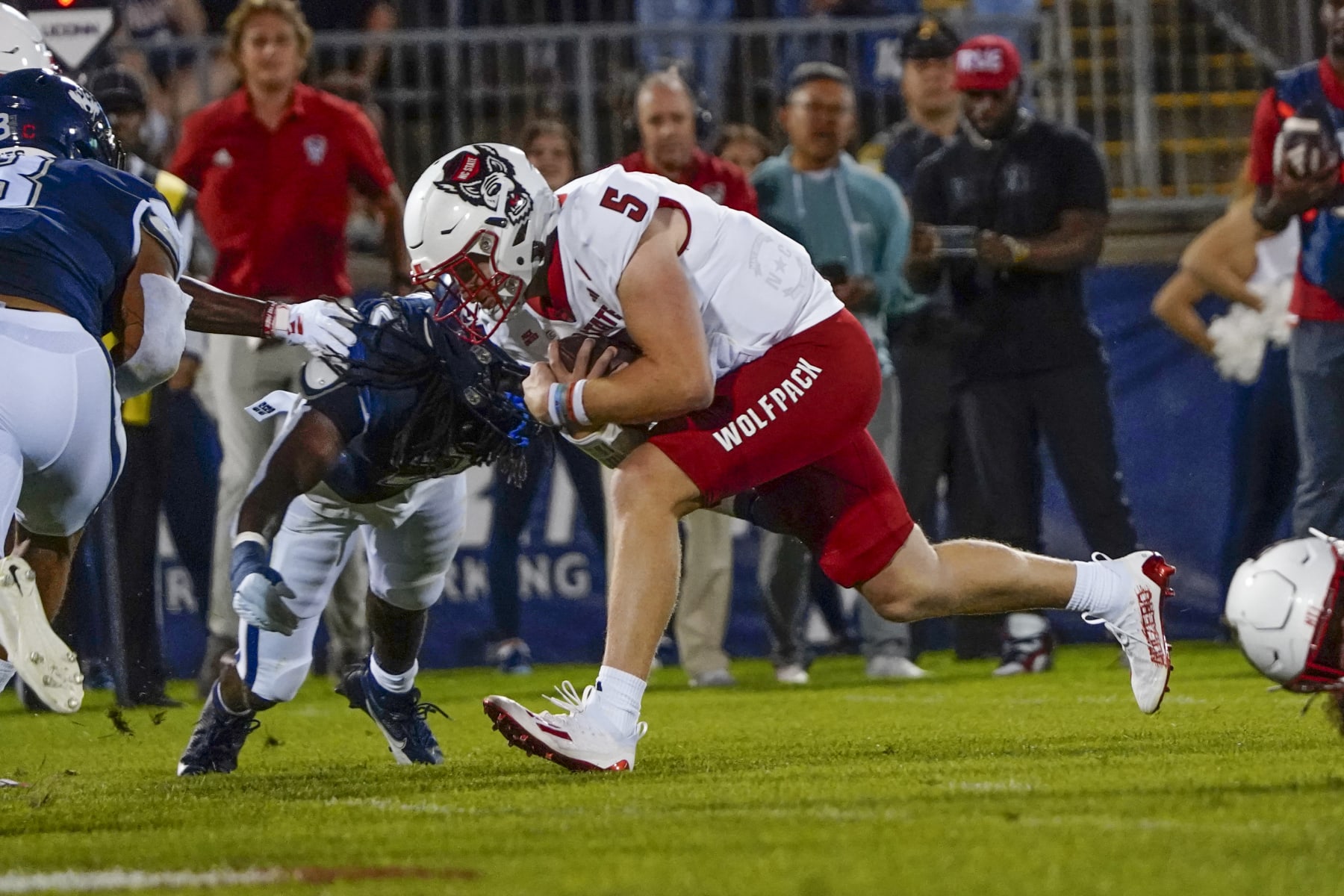 EAST HARTFORD, CT - AUGUST 31: North Carolina State Wolfpack Quarterback Brennan Armstrong (5) runs for a touchdown during the first half of the College Football game between the North Carolina State Wolfpack and the Connecticut Huskies on August 31, 2023,, at Pratt and Whitney Stadium in East Hartford, CT. (Photo by Gregory Fisher/Icon Sportswire via Getty Images)