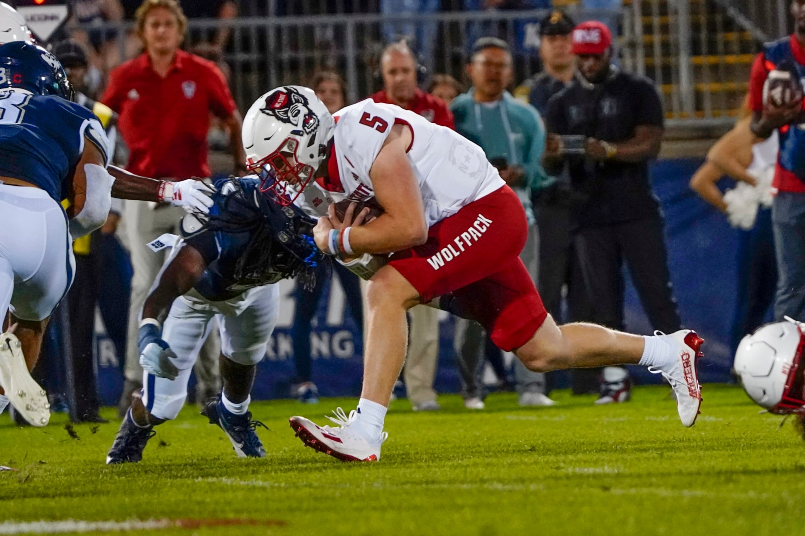 EAST HARTFORD, CT - AUGUST 31: North Carolina State Wolfpack Quarterback Brennan Armstrong (5) runs for a touchdown during the first half of the College Football game between the North Carolina State Wolfpack and the Connecticut Huskies on August 31, 2023,, at Pratt and Whitney Stadium in East Hartford, CT. (Photo by Gregory Fisher/Icon Sportswire via Getty Images) EAST HARTFORD, CT - AUGUST 31: North Carolina State Wolfpack Quarterback Brennan Armstrong (5) runs for a touchdown during the first half of the College Football game between the North Carolina State Wolfpack and the Connecticut Huskies on August 31, 2023,, at Pratt and Whitney Stadium in East Hartford, CT. (Photo by Gregory Fisher/Icon Sportswire via Getty Images)