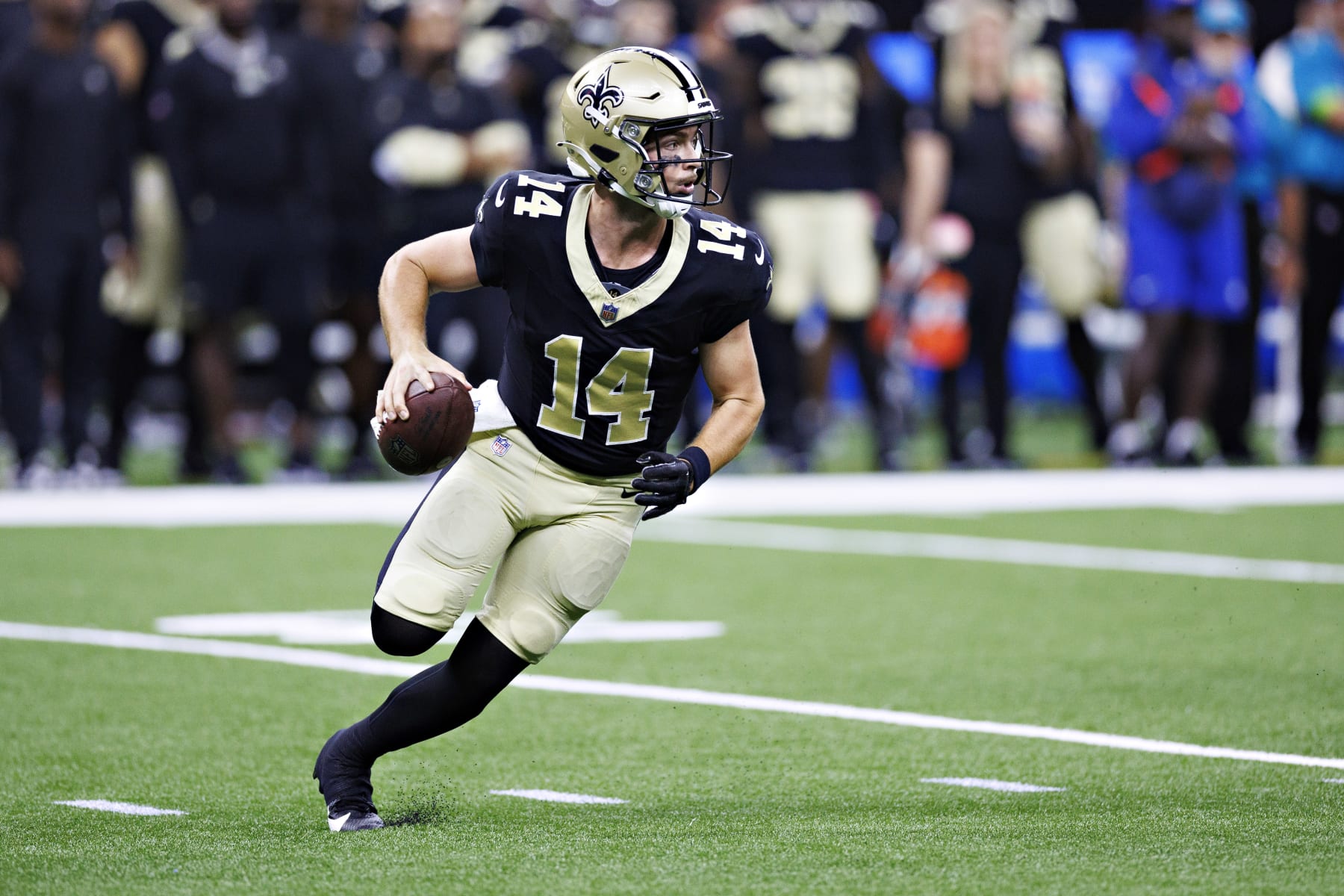 NEW ORLEANS, LOUISIANA - AUGUST 27: Jake Haener #14 of the New Orleans Saints rolls out looking for a receiver during the preseason game against the Houston Texans at Caesars Superdome on August 27, 2023 in New Orleans, Louisiana. (Photo by Wesley Hitt/Getty Images)