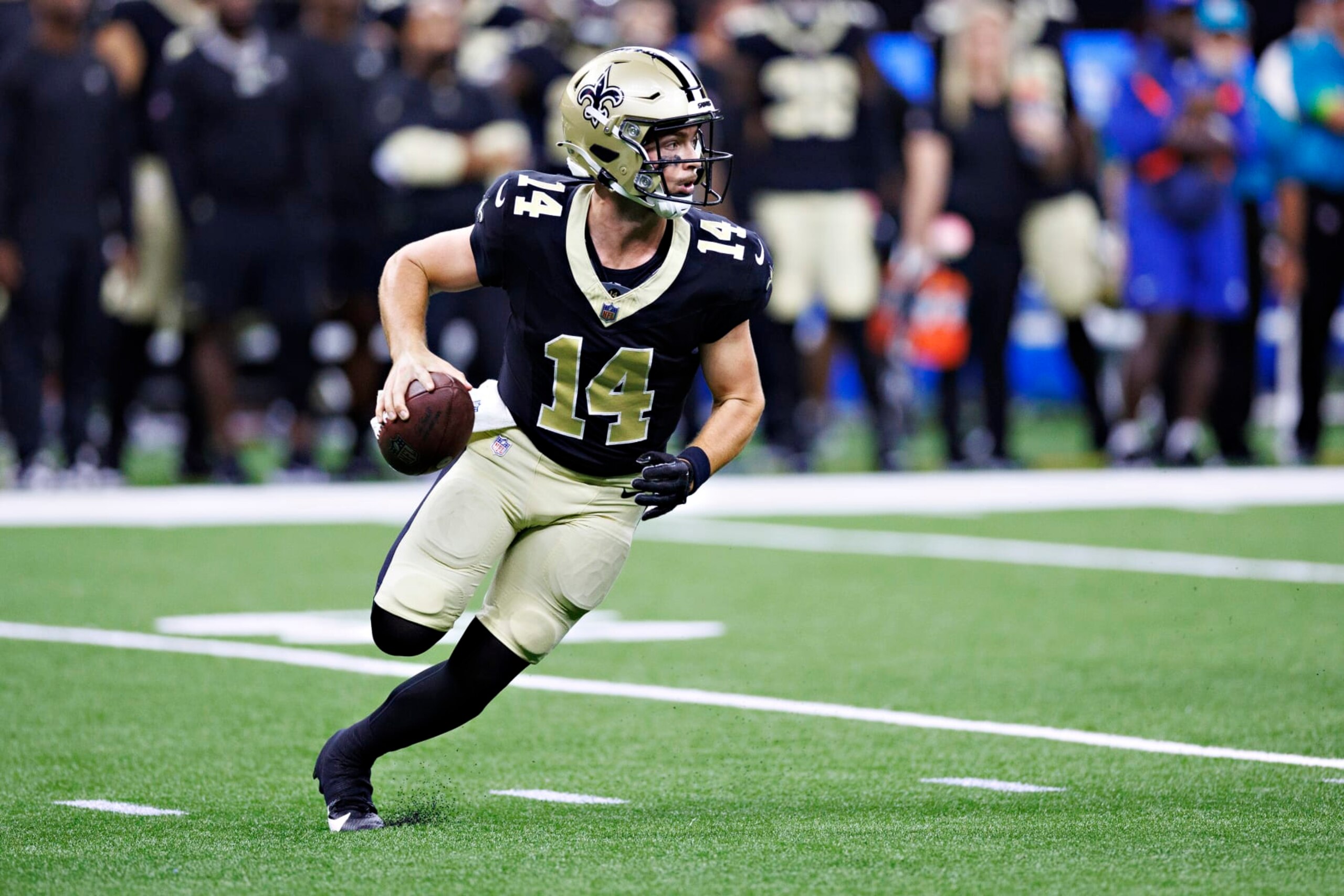 NEW ORLEANS, LOUISIANA - AUGUST 27: Jake Haener #14 of the New Orleans Saints rolls out looking for a receiver during the preseason game against the Houston Texans at Caesars Superdome on August 27, 2023 in New Orleans, Louisiana. (Photo by Wesley Hitt/Getty Images)