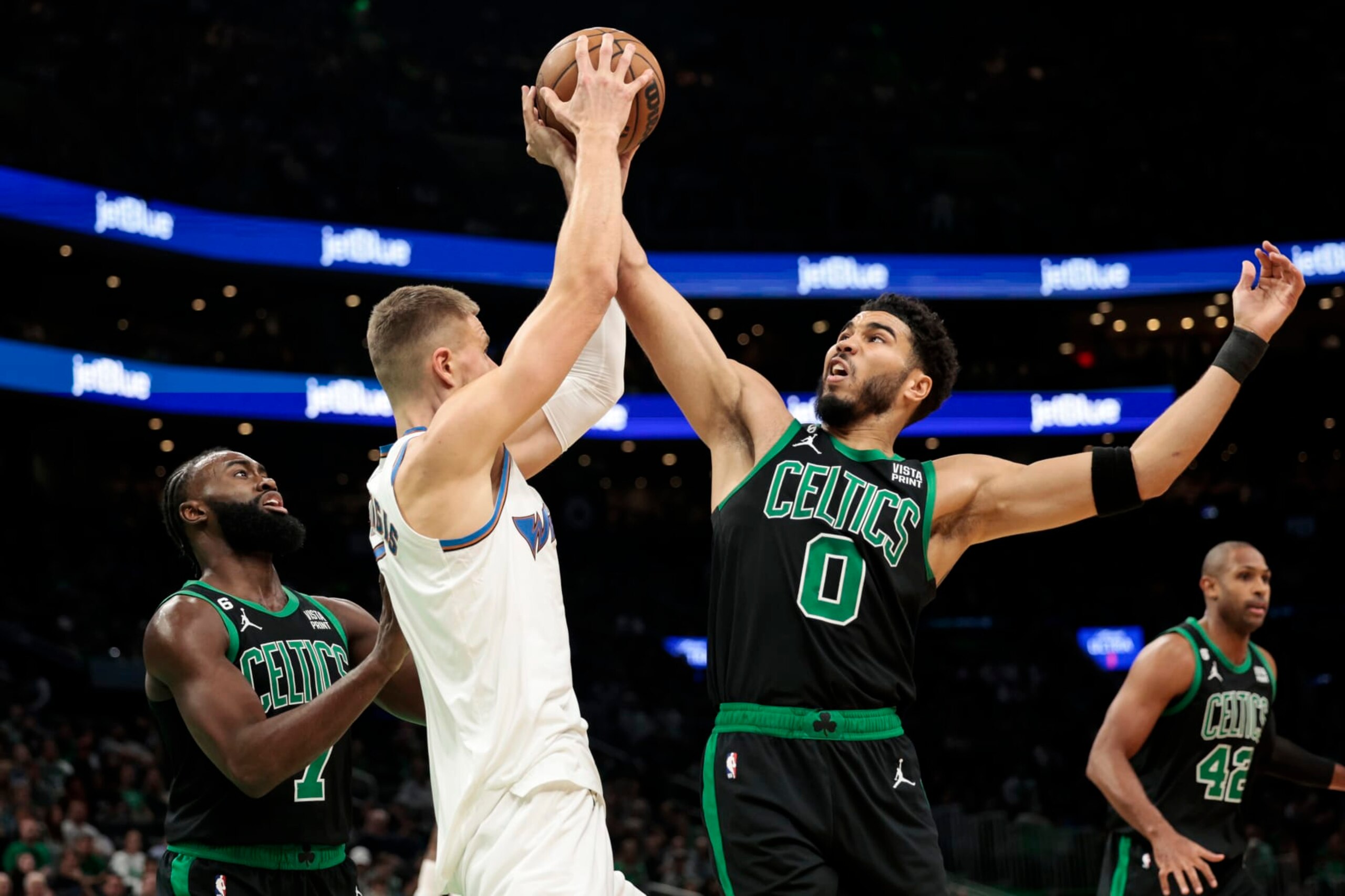 BOSTON, MASSACHUSETTS - OCTOBER 30: Jayson Tatum #0 of the Boston Celtics fights for the rebound with Kristaps Porzingis #6 of the Washington Wizards during the first quarter at TD Garden on October 30, 2022 in Boston, Massachusetts. NOTE TO USER: User expressly acknowledges and agrees that, by downloading and or using this photograph, User is consenting to the terms and conditions of the Getty Images License Agreement. (Photo by Nick Grace/Getty Images)