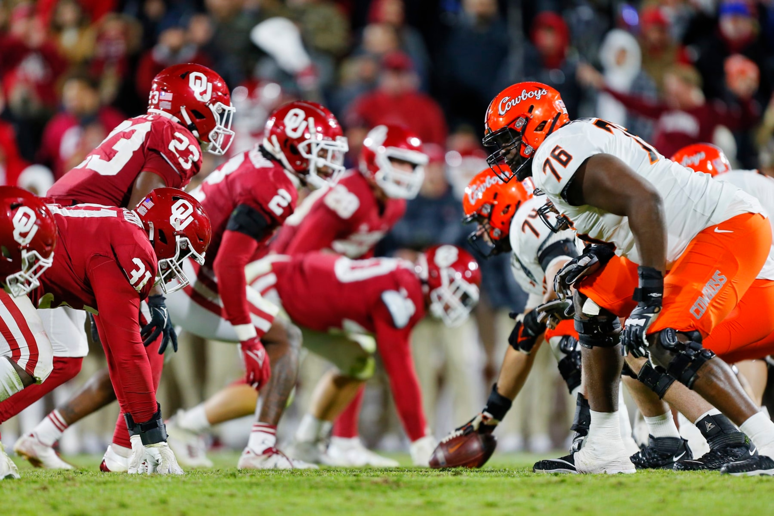 NORMAN, OK - NOVEMBER 19:  Defensive tackle Jalen Redmond #31 and the Oklahoma Sooners defensive line faces off against left tackle Caleb Etienne #76 and the Oklahoma State Cowboys offensive line in the fourth quarter during Bedlam at Gaylord Family Oklahoma Memorial Stadium on November 19, 2022 in Norman, Oklahoma.  The Sooners won 28-13.  (Photo by Brian Bahr/Getty Images)