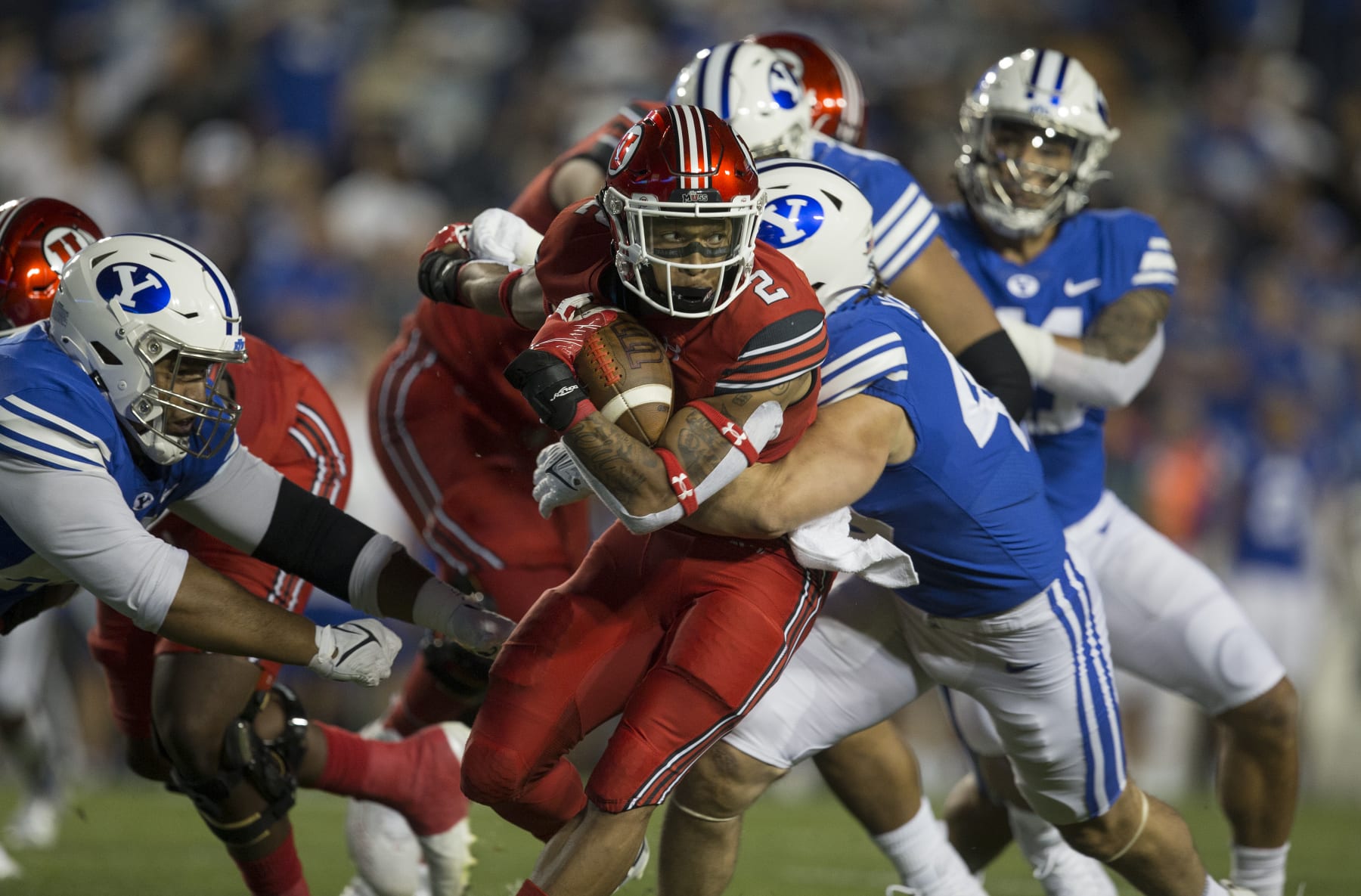 PROVO, UT -  SEPTEMBER 11 : Micah Bernard #2 of the Utah Utes rushes against Payton Wilgar #49 and Atunaisa Mahe #62 of the BYU Cougars during their game September 11, 2021 at LaVell Edwards Stadium in Logan, Utah. (Photo by Chris Gardner/Getty Images)
