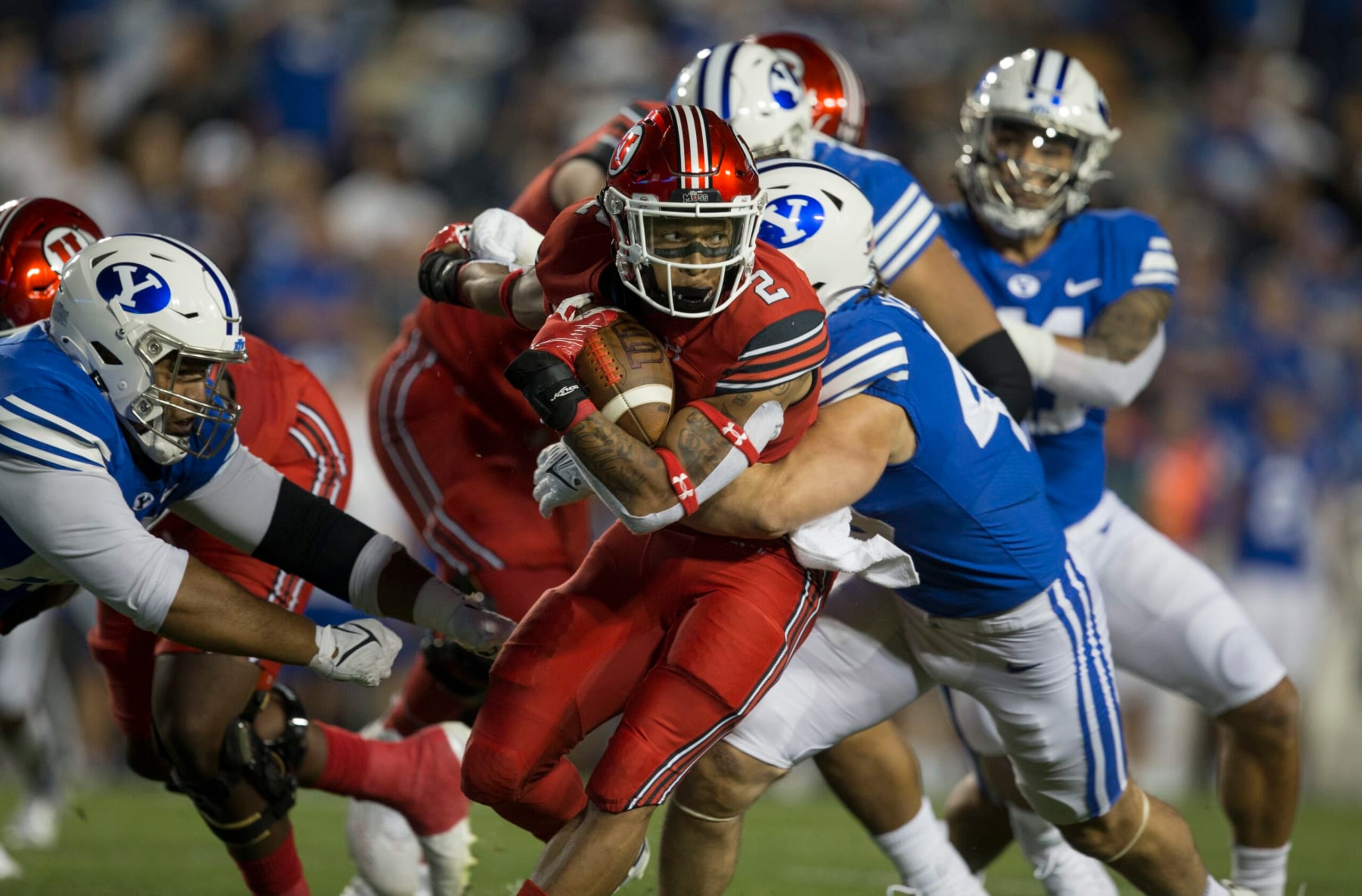 PROVO, UT - SEPTEMBER 11 : Micah Bernard #2 of the Utah Utes rushes against Payton Wilgar #49 and Atunaisa Mahe #62 of the BYU Cougars during their game September 11, 2021 at LaVell Edwards Stadium in Logan, Utah. (Photo by Chris Gardner/Getty Images) PROVO, UT - SEPTEMBER 11 : Micah Bernard #2 of the Utah Utes rushes against Payton Wilgar #49 and Atunaisa Mahe #62 of the BYU Cougars during their game September 11, 2021 at LaVell Edwards Stadium in Logan, Utah. (Photo by Chris Gardner/Getty Images)