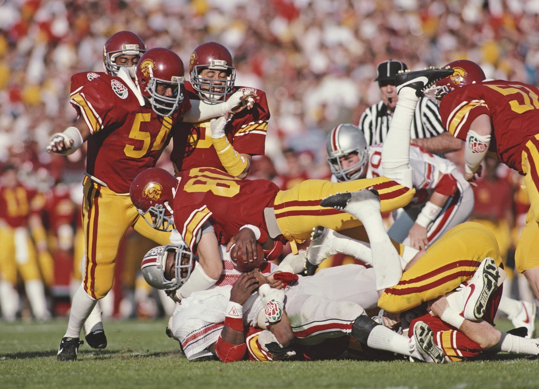 Duane Bickett #80, Linebacker for the University of Southern California USC Trojans tackles Keith Byars of the Ohio State Buckeyes during the NCAA 71st Rose Bowl college football game on 1 January 1985 at the Rose Bowl Stadium, Pasadena, California, United States. The USC Trojans won the game  20 - 17.   (Photo by Rick Stewart/Allsport/Getty Images)