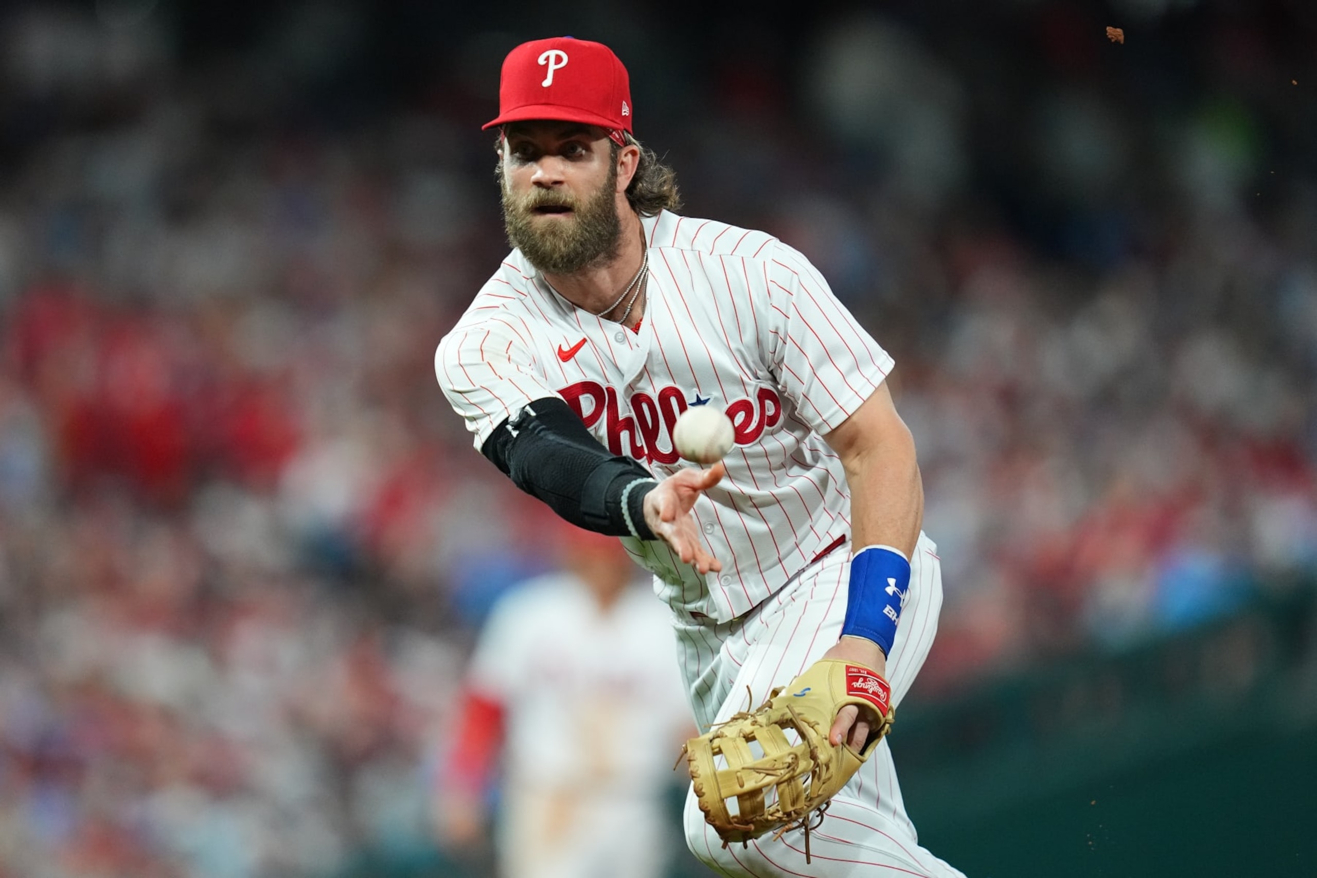 PHILADELPHIA, PENNSYLVANIA - AUGUST 28: Bryce Harper #3 of the Philadelphia Phillies tosses the ball to first base to force out Shohei Ohtani #17 of the Los Angeles Angels in the top of the eighth inning at Citizens Bank Park on August 28, 2023 in Philadelphia, Pennsylvania. The Phillies defeated the Angels 6-4. (Photo by Mitchell Leff/Getty Images)