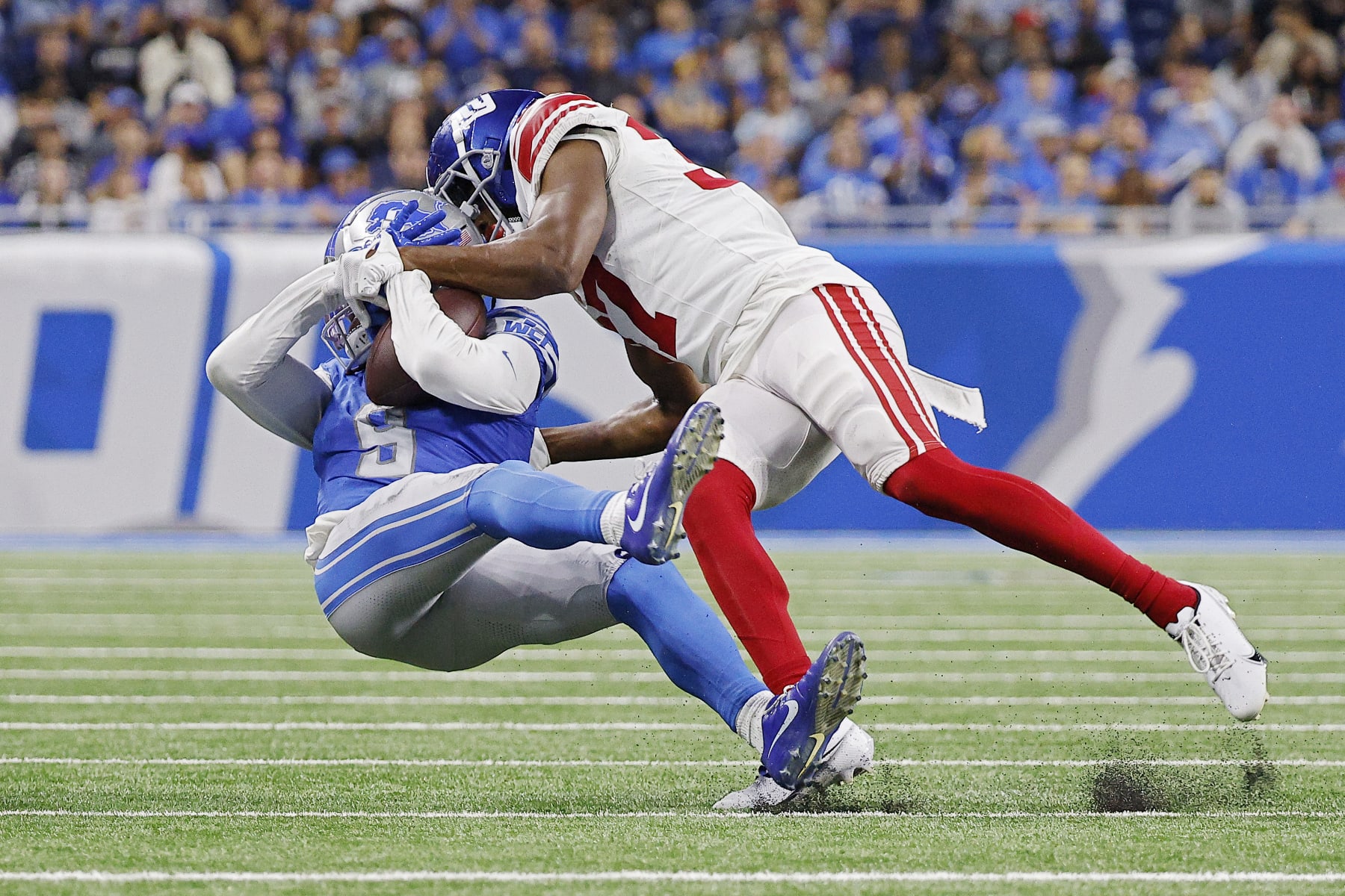 DETROIT, MICHIGAN - AUGUST 11: Tre Hawkins III #37 of the New York Giants tackles Jameson Williams #9 of the Detroit Lions in the second quarter of a preseason game at Ford Field on August 11, 2023 in Detroit, Michigan. (Photo by Mike Mulholland/Getty Images)