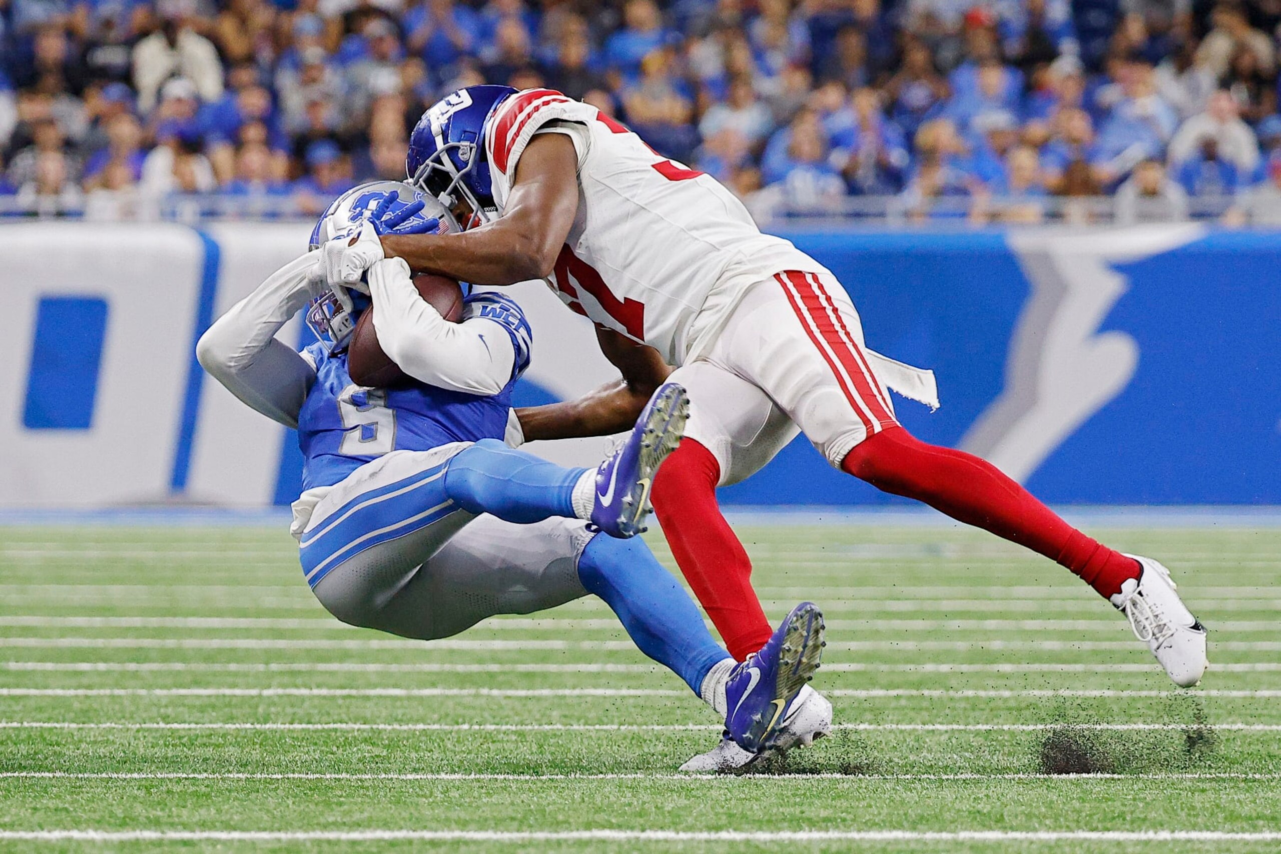 DETROIT, MICHIGAN - AUGUST 11: Tre Hawkins III #37 of the New York Giants tackles Jameson Williams #9 of the Detroit Lions in the second quarter of a preseason game at Ford Field on August 11, 2023 in Detroit, Michigan. (Photo by Mike Mulholland/Getty Images)