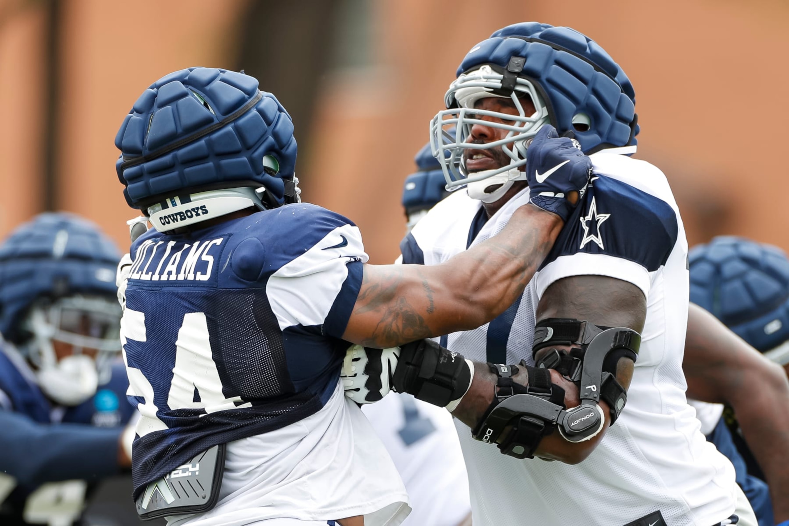 OXNARD, CA - AUGUST 15: Dallas Cowboys defensive end Sam Williams (54) blocks against offensive tackle Tyron Smith (77) during a drill in the team's training camp at Marriott Residence Inn at River Ridge on August 15, 2023, in Oxnard, CA. (Photo by Brandon Sloter/Icon Sportswire via Getty Images)