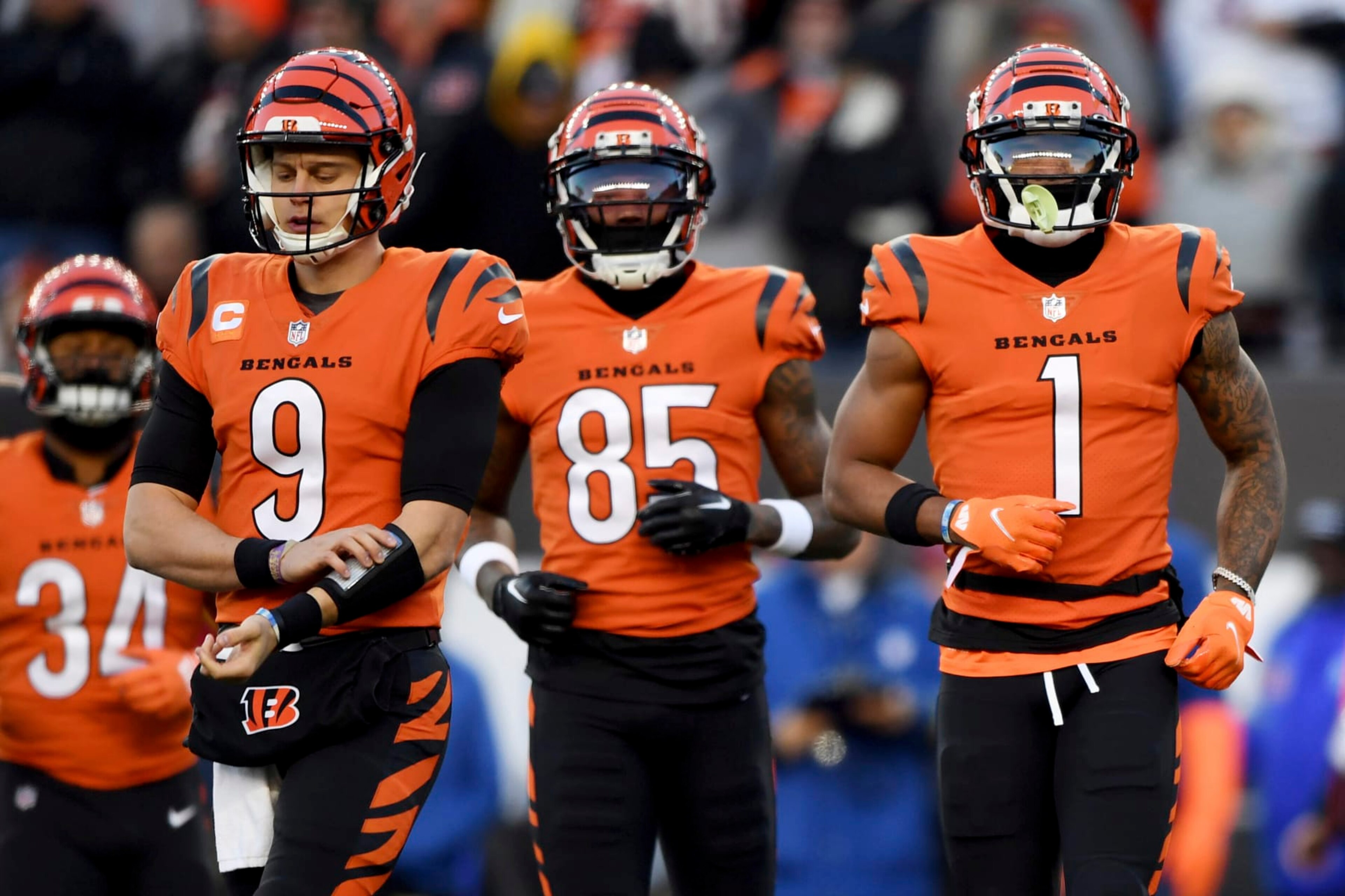 Cincinnati Bengals quarterback Joe Burrow (9), wide receiver Tee Higgins (85) and Cincinnati Bengals wide receiver Ja'Marr Chase (1) run onto the field during an NFL football game against the Kansas City Chiefs, Sunday, Dec. 4, 2022, in Cincinnati. (AP Photo/Emilee Chinn)