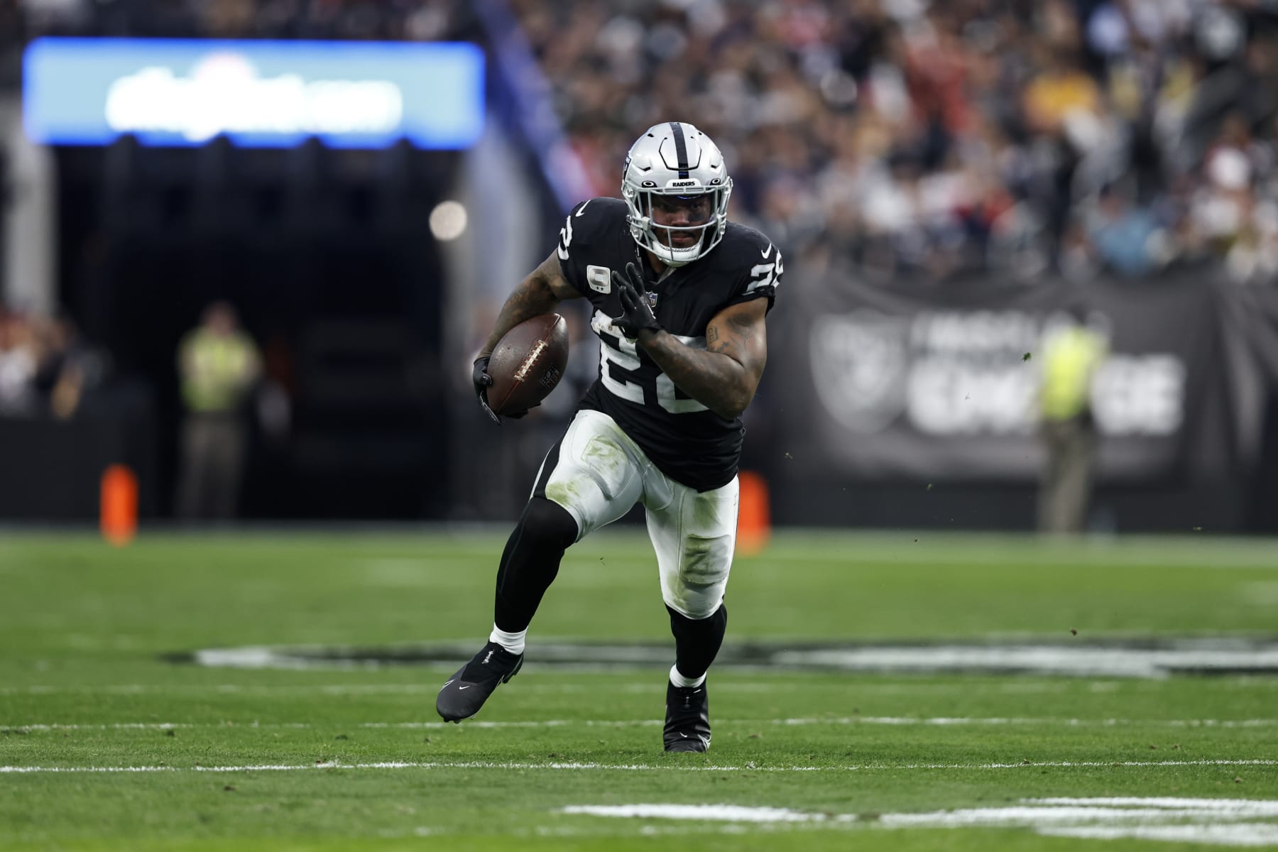 LAS VEGAS, NEVADA - DECEMBER 18: Josh Jacobs #28 of the Las Vegas Raiders runs with the ball during an NFL football game between the Las Vegas Raiders and the New England Patriots at Allegiant Stadium on December 18, 2022 in Las Vegas, Nevada. (Photo by Michael Owens/Getty Images)