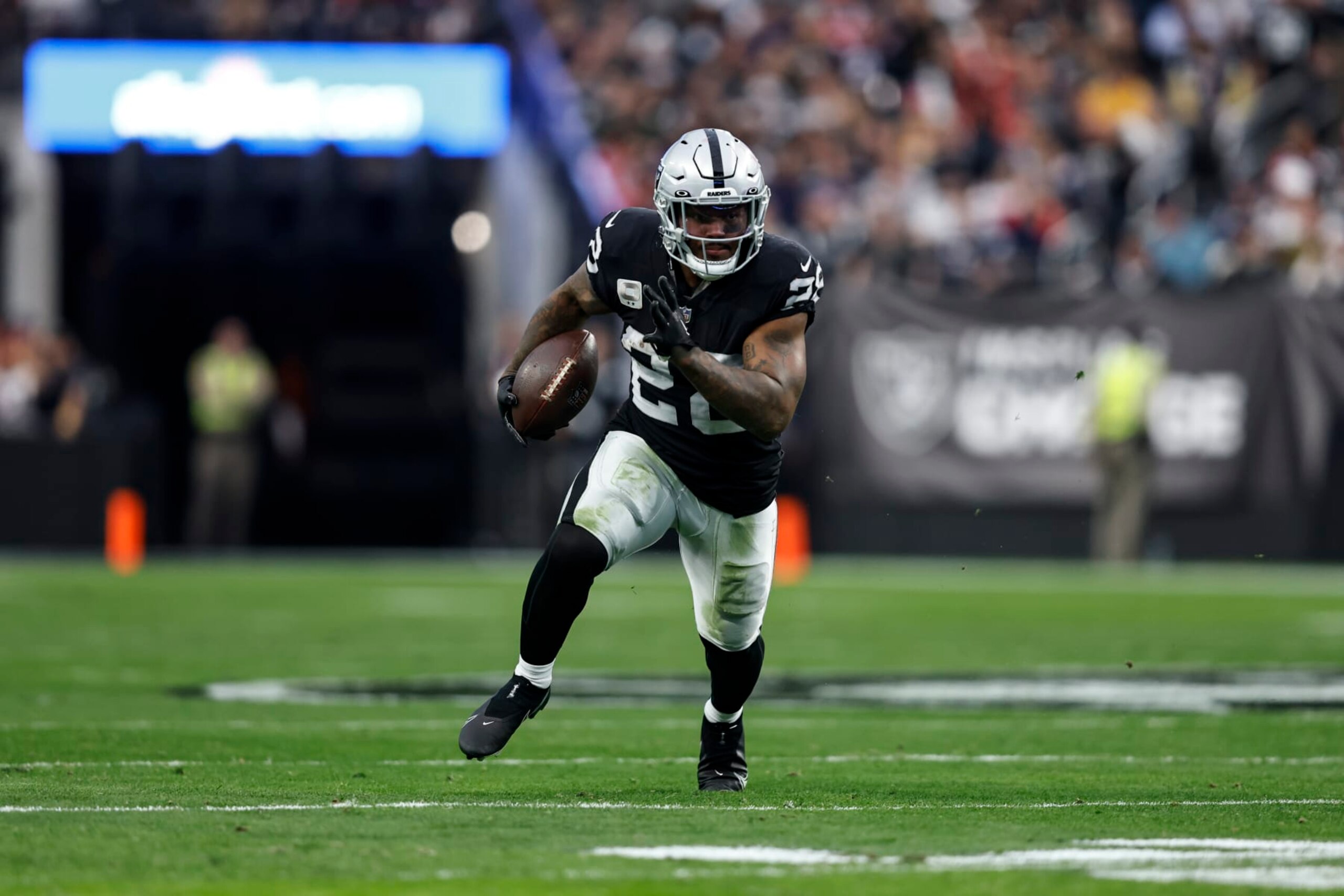LAS VEGAS, NEVADA - DECEMBER 18: Josh Jacobs #28 of the Las Vegas Raiders runs with the ball during an NFL football game between the Las Vegas Raiders and the New England Patriots at Allegiant Stadium on December 18, 2022 in Las Vegas, Nevada. (Photo by Michael Owens/Getty Images)