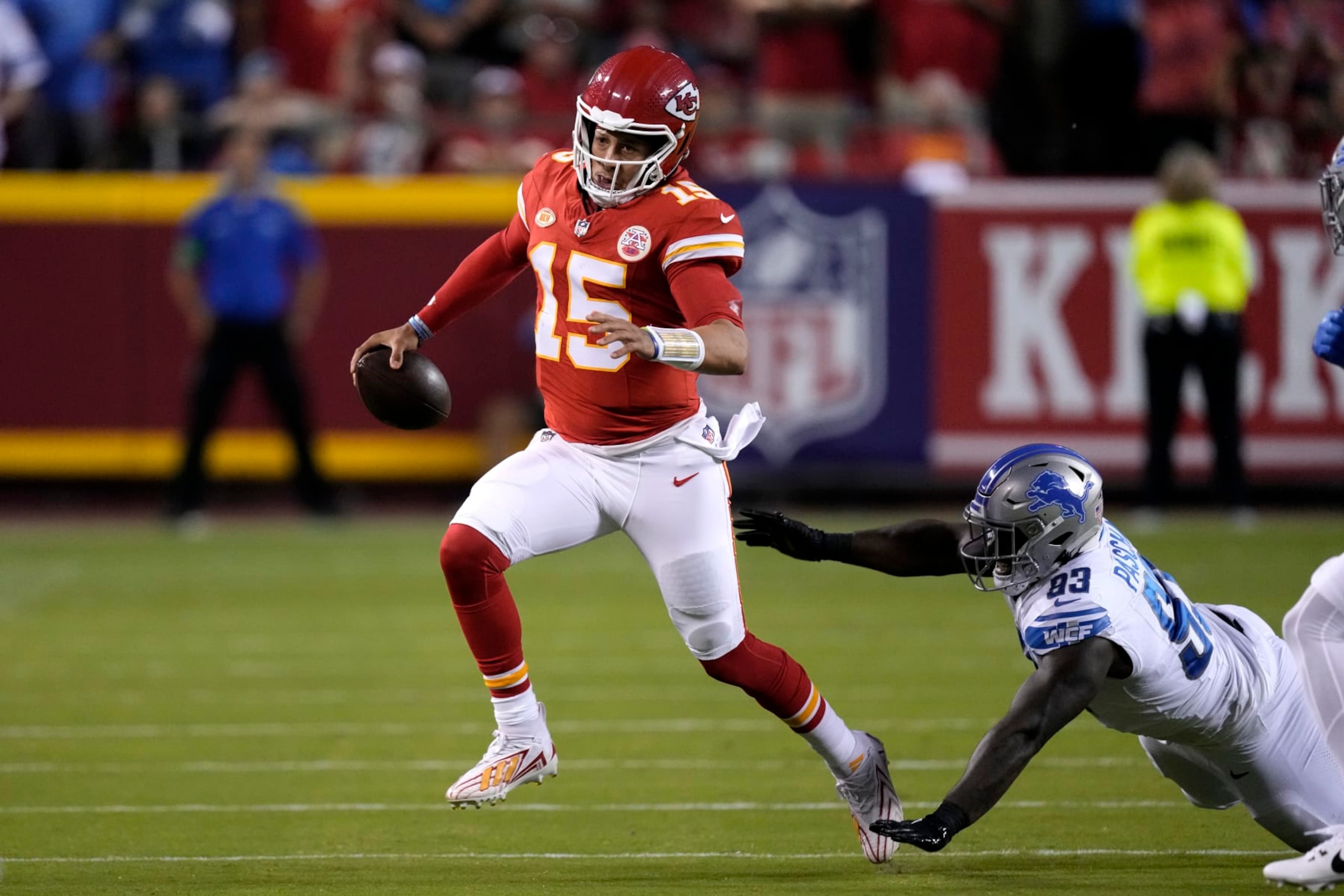 Kansas City Chiefs quarterback Patrick Mahomes (15) scrambles past Detroit Lions defensive end Josh Paschal (93) during the first half of an NFL football game Thursday, Sept. 7, 2023, in Kansas City, Mo. (AP Photo/Charlie Riedel)
