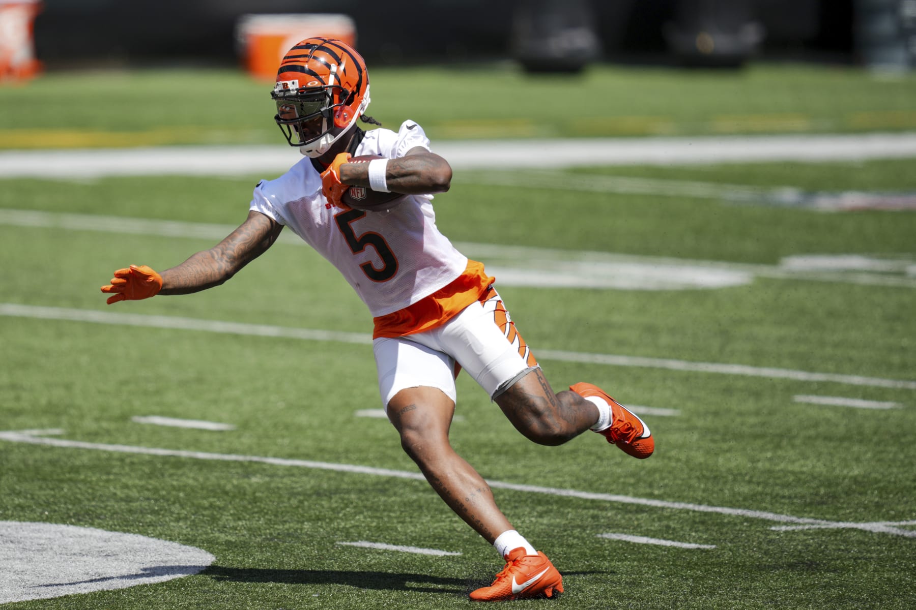 Cincinnati Bengals' Tee Higgins carries the ball after making a catch in a drill during the NFL football team's training camp in Cincinnati, Saturday, July 29, 2023. (AP Photo/Aaron Doster)
