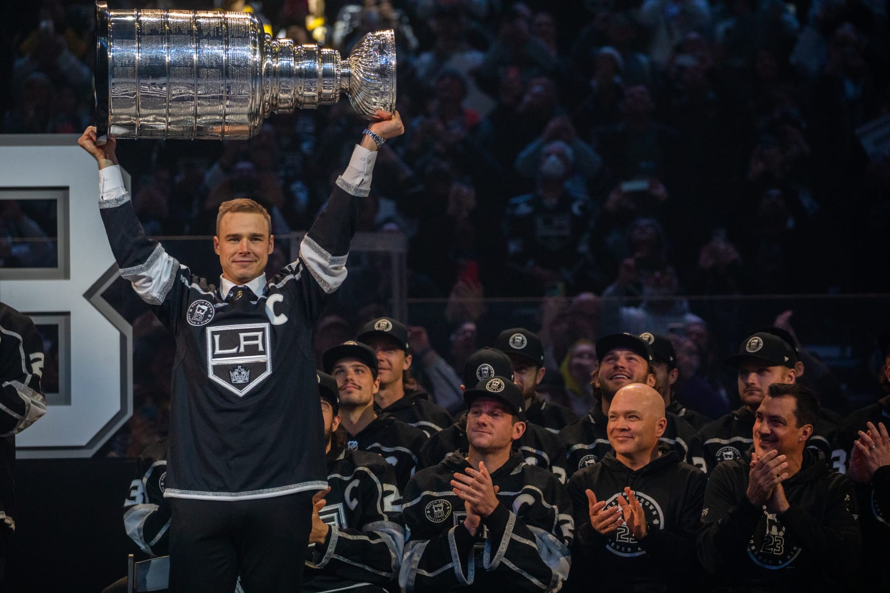 LOS ANGELES, CA - FEBRUARY 11, 2023: Dustin Brown holds up The Stanley Cup at an event where LA Kings retires Dustin Browns No. 23 at Crypto.com Arena Saturday, February 11, 2023, in Los Angeles, CA. Brown is the seventh Kings player to receive the honor of having his number (23) retired. Dustin Brown is the franchises all-time games-played leader and the first player in team history to lift the Stanley Cup.  (Francine Orr/ Los Angeles Times via Getty Images)