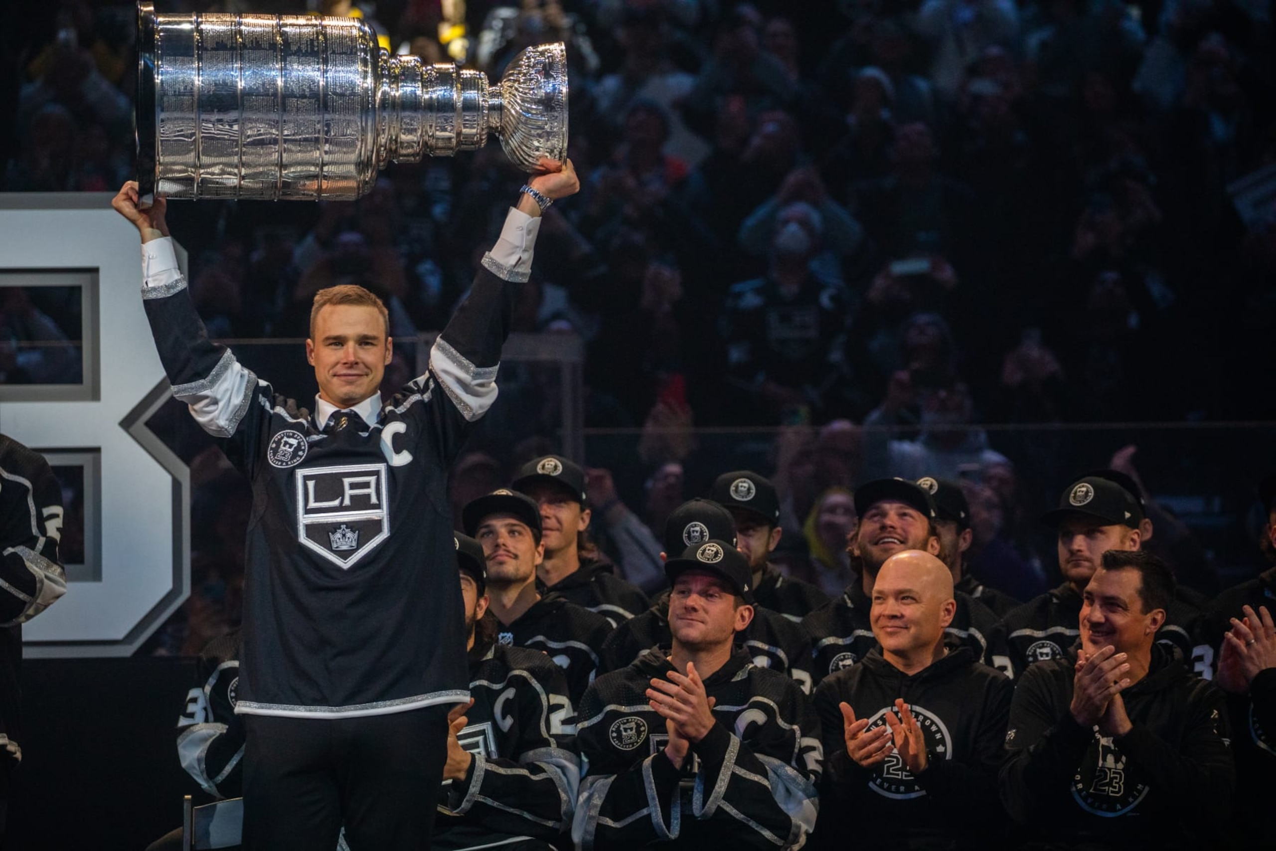 LOS ANGELES, CA - FEBRUARY 11, 2023: Dustin Brown holds up The Stanley Cup at an event where LA Kings retires Dustin Browns No. 23 at Crypto.com Arena Saturday, February 11, 2023, in Los Angeles, CA. Brown is the seventh Kings player to receive the honor of having his number (23) retired. Dustin Brown is the franchises all-time games-played leader and the first player in team history to lift the Stanley Cup.  (Francine Orr/ Los Angeles Times via Getty Images)