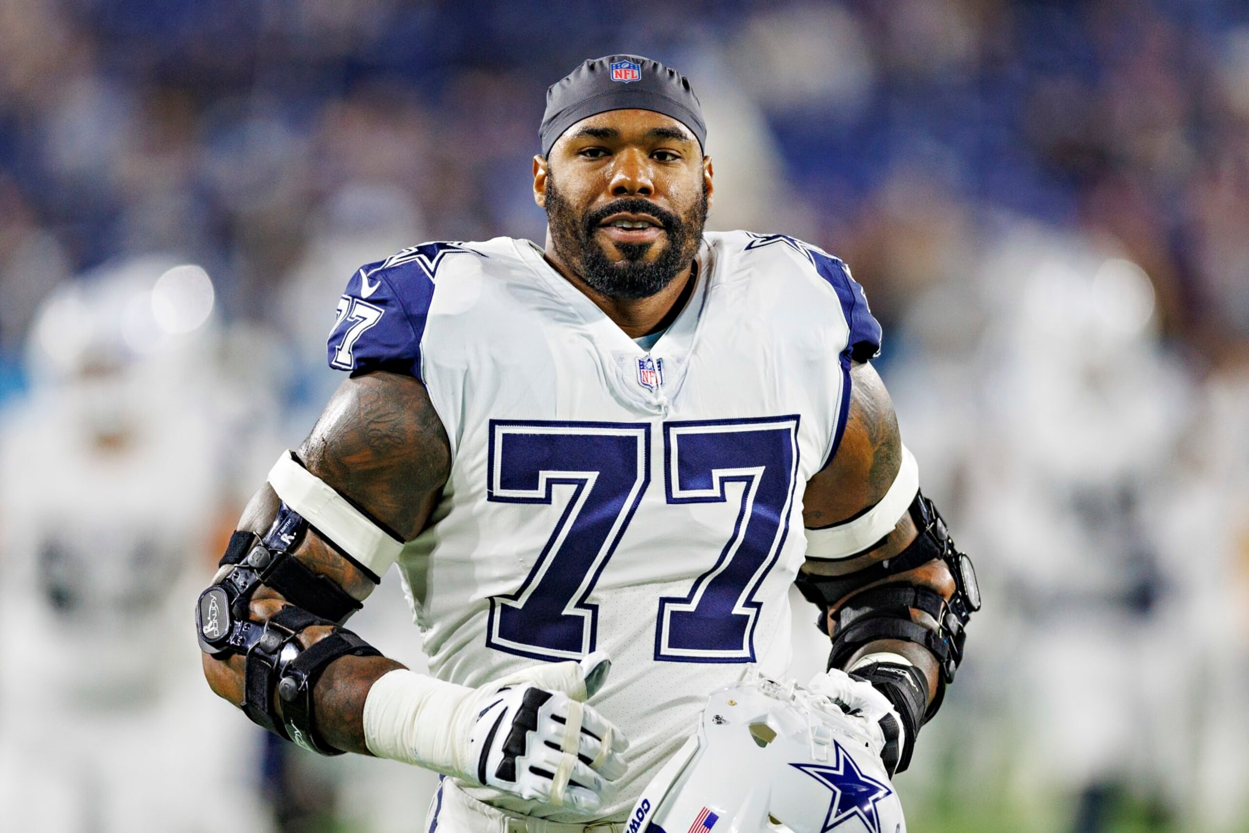 NASHVILLE, TENNESSEE - DECEMBER 29: Tyron Smith #77 of the Dallas Cowboys jogs to the locker room before a game against the Tennessee Titans at Nissan Stadium on December 29, 2022 in Nashville, Tennessee. The Cowboys defeated the Titans 27-13. (Photo by Wesley Hitt/Getty Images) NASHVILLE, TENNESSEE - DECEMBER 29: Tyron Smith #77 of the Dallas Cowboys jogs to the locker room before a game against the Tennessee Titans at Nissan Stadium on December 29, 2022 in Nashville, Tennessee. The Cowboys defeated the Titans 27-13. (Photo by Wesley Hitt/Getty Images)