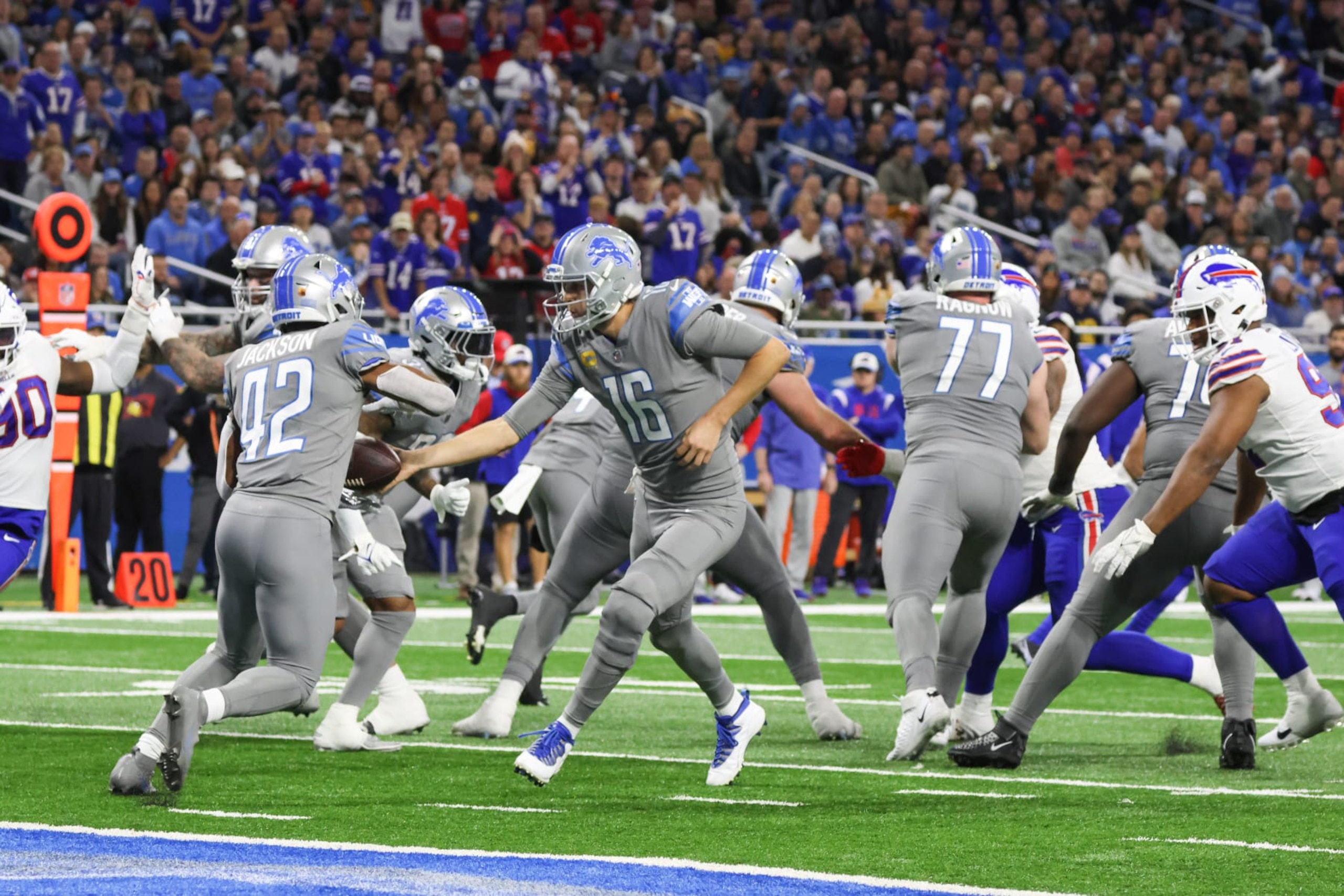 DETROIT, MI - NOVEMBER 24:  Detroit Lions quarterback Jared Goff (16) hands the ball off to Detroit Lions running back Justin Jackson (42) during a regular season NFL football game between the Buffalo Bills and the Detroit Lions on Thanksgiving Day on November 24, 2022 at Ford Field in Detroit, Michigan.  (Photo by Scott W. Grau/Icon Sportswire via Getty Images)