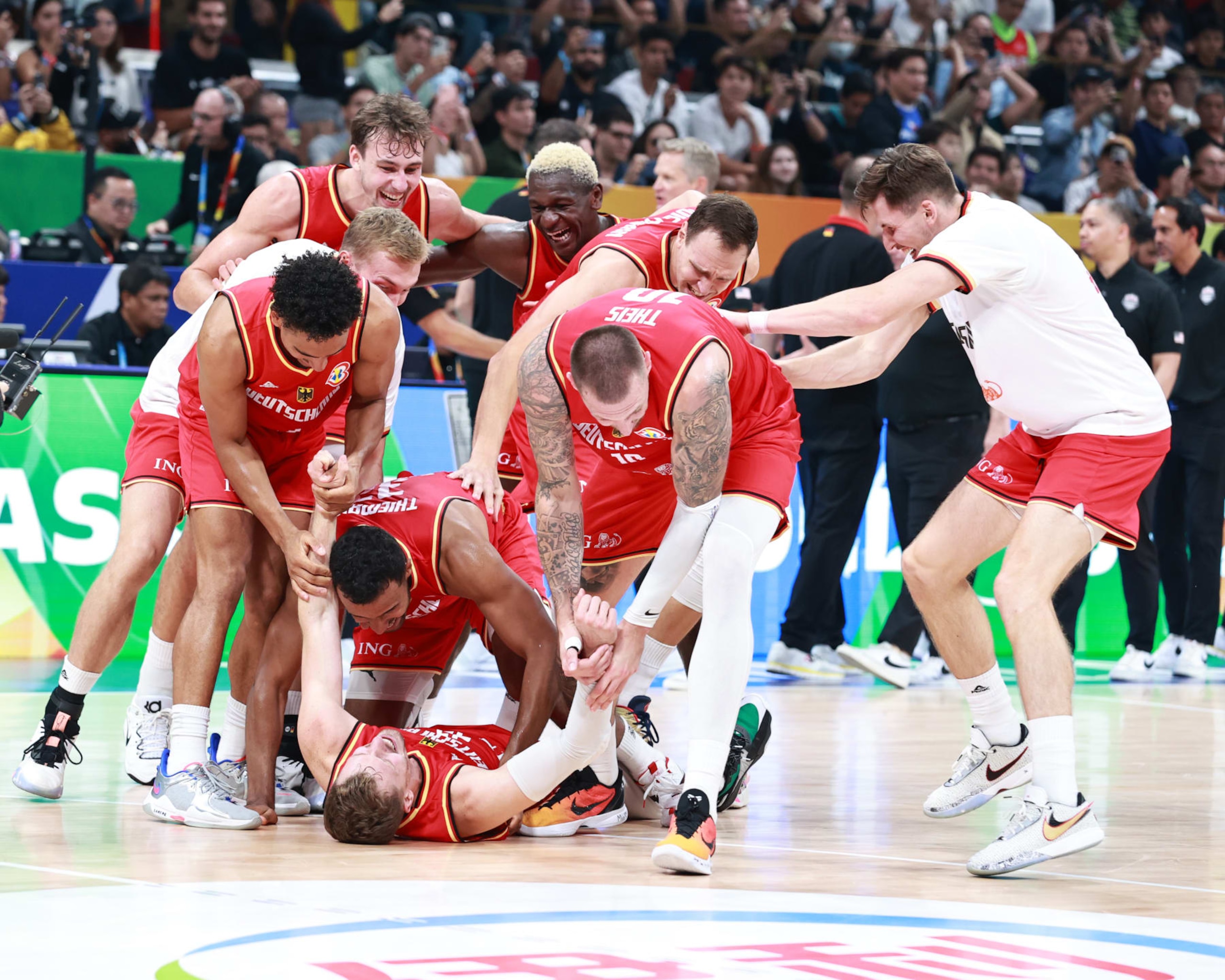 MANILA, PHILIPPINES - SEPTEMBER 8: The German Mens National team celebrates after the game in the semi-finals as part of the 2023 FIBA World Cup on September 8, 2023 at Mall of Asia Arena in Manila, Philippines. NOTE TO USER: User expressly acknowledges and agrees that, by downloading and/or using this photograph, user is consenting to the terms and conditions of the Getty Images License Agreement. Mandatory Copyright Notice: Copyright 2023 NBAE (Photo by Nathaniel S. Butler/NBAE via Getty Images) MANILA, PHILIPPINES - SEPTEMBER 8: The German Mens National team celebrates after the game in the semi-finals as part of the 2023 FIBA World Cup on September 8, 2023 at Mall of Asia Arena in Manila, Philippines. NOTE TO USER: User expressly acknowledges and agrees that, by downloading and/or using this photograph, user is consenting to the terms and conditions of the Getty Images License Agreement. Mandatory Copyright Notice: Copyright 2023 NBAE (Photo by Nathaniel S. Butler/NBAE via Getty Images)