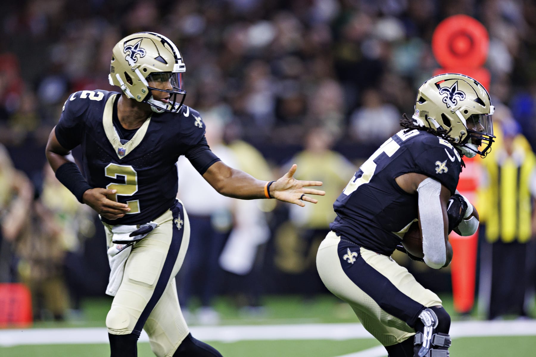 NEW ORLEANS, LOUISIANA - AUGUST 27:  Jameis Winston #2 hands off the ball to Kendre Miller #25 of the New Orleans Saints during the preseason game against the Houston Texans at Caesars Superdome on August 27, 2023 in New Orleans, Louisiana. The Texans defeated the Saints 17-13.  (Photo by Wesley Hitt/Getty Images)