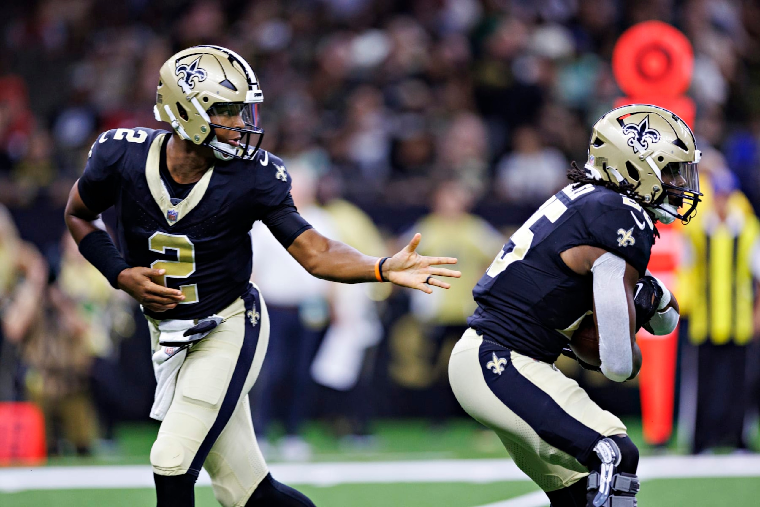 NEW ORLEANS, LOUISIANA - AUGUST 27:  Jameis Winston #2 hands off the ball to Kendre Miller #25 of the New Orleans Saints during the preseason game against the Houston Texans at Caesars Superdome on August 27, 2023 in New Orleans, Louisiana. The Texans defeated the Saints 17-13.  (Photo by Wesley Hitt/Getty Images)