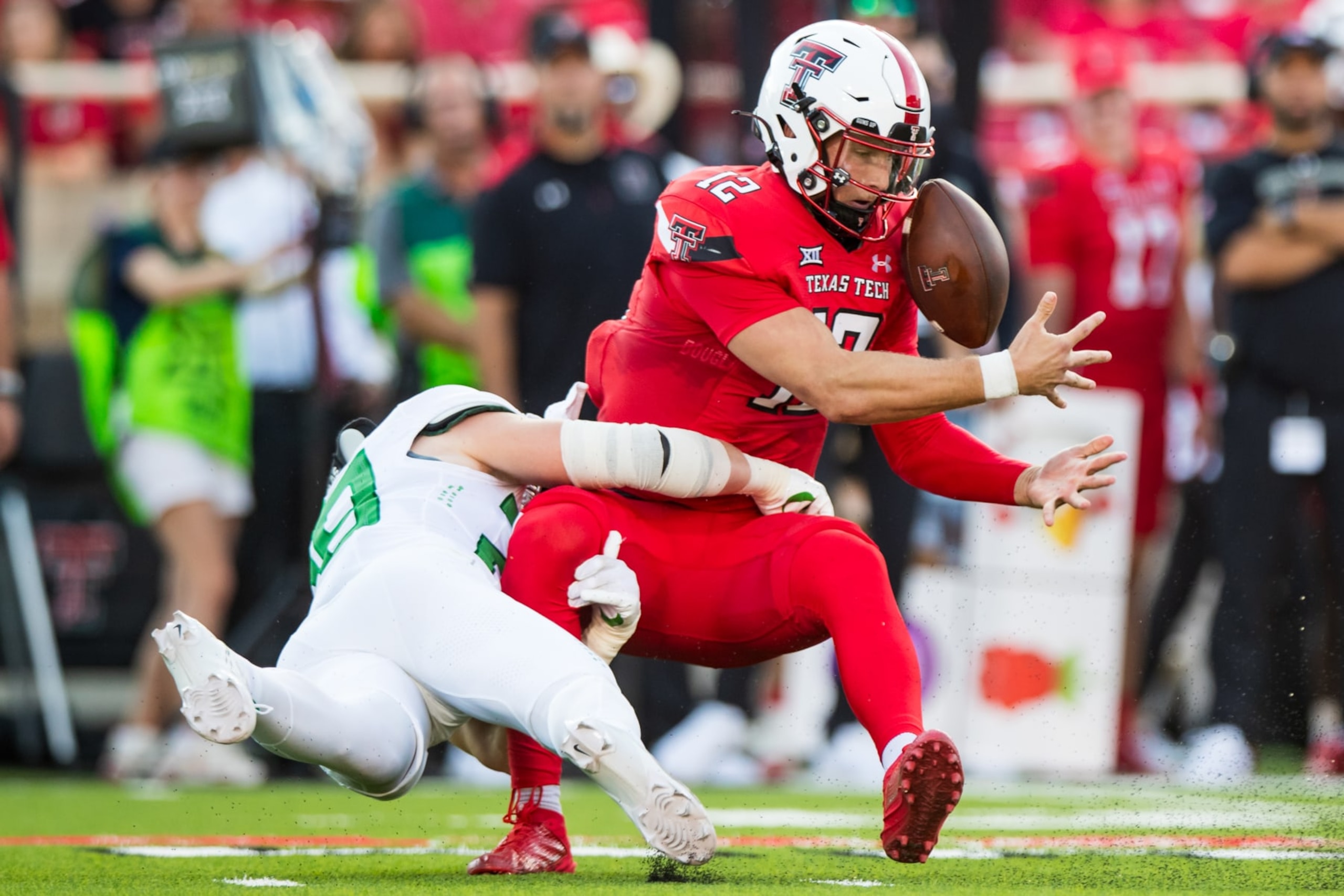 LUBBOCK, TEXAS - SEPTEMBER 09: Quarterback Tyler Shough #12 of the Texas Tech Red Raiders fumbles the ball while being tackled by Bryce Boettcher #28 of the Oregon Ducks during the first half of the game at Jones AT&T Stadium on September 09, 2023 in Lubbock, Texas. (Photo by John E. Moore III/Getty Images)