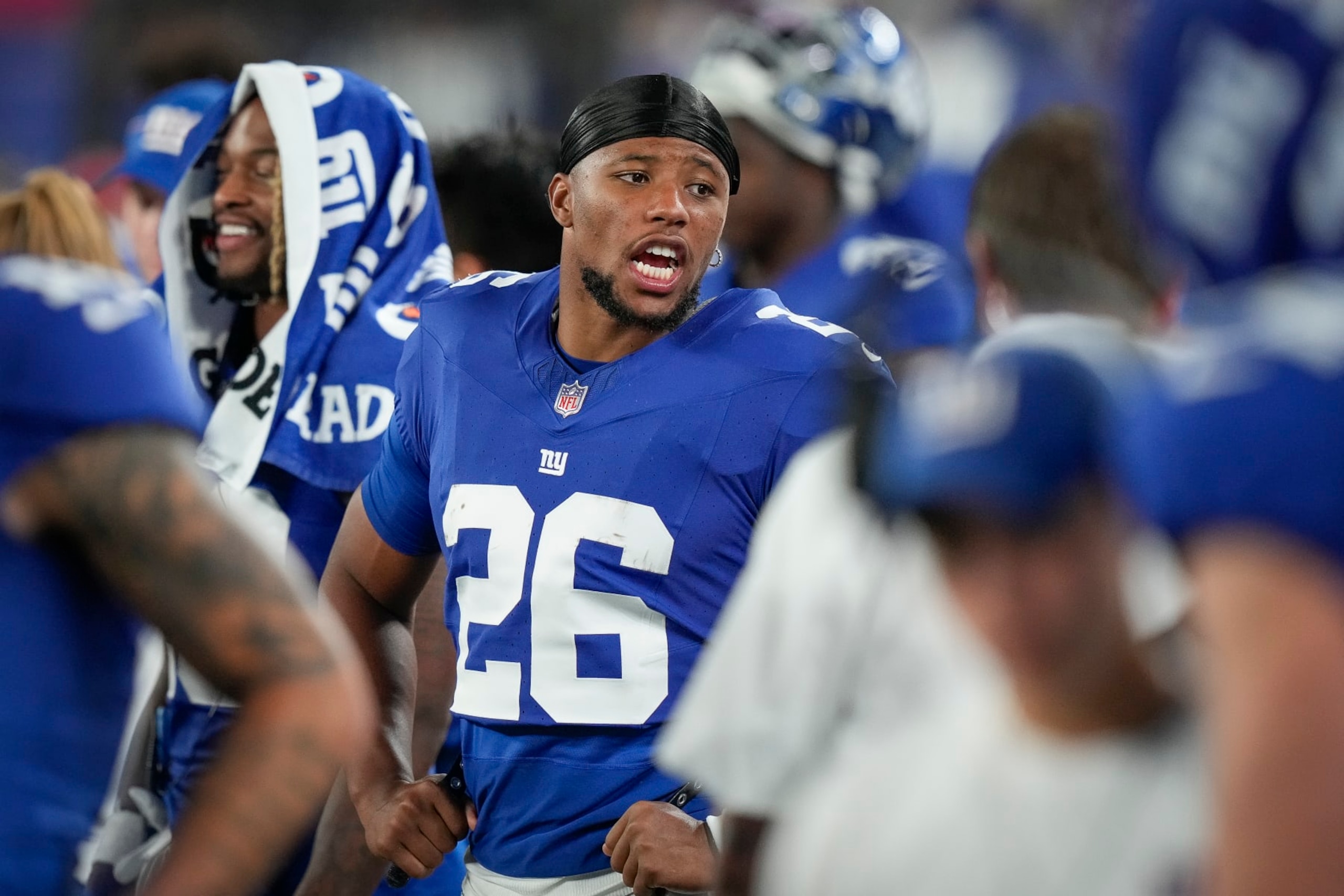 New York Giants running back Saquon Barkley stands on the sidelines during the second half of an NFL preseason football game against the Carolina Panthers, Friday, Aug. 18, 2023, in East Rutherford, N.J. (AP Photo/Bryan Woolston)
