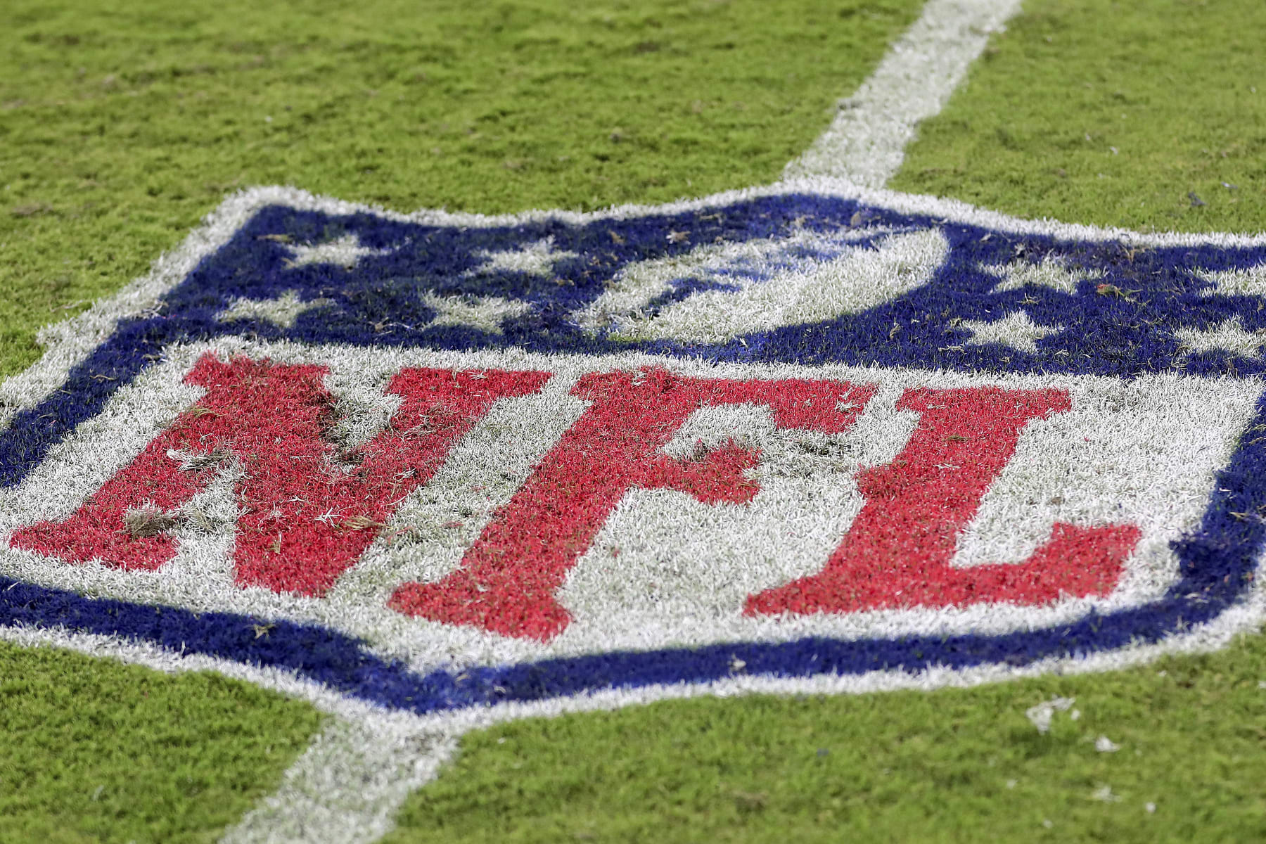 The NFL logo is painted on the turf during a NFL football game at EverBank Stadium, Saturday, August 26, 2023 in Jacksonville, Fla. (AP Photo/Alex Menendez)