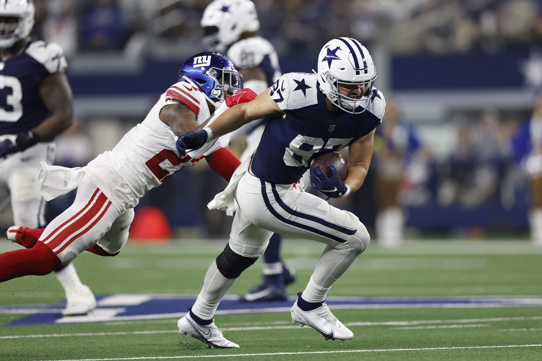 ARLINGTON, TEXAS - NOVEMBER 24: Jake Ferguson #87 of the Dallas Cowboys runs with the ball during the second half in the game against the New York Giants at AT&T Stadium on November 24, 2022 in Arlington, Texas. (Photo by Wesley Hitt/Getty Images)