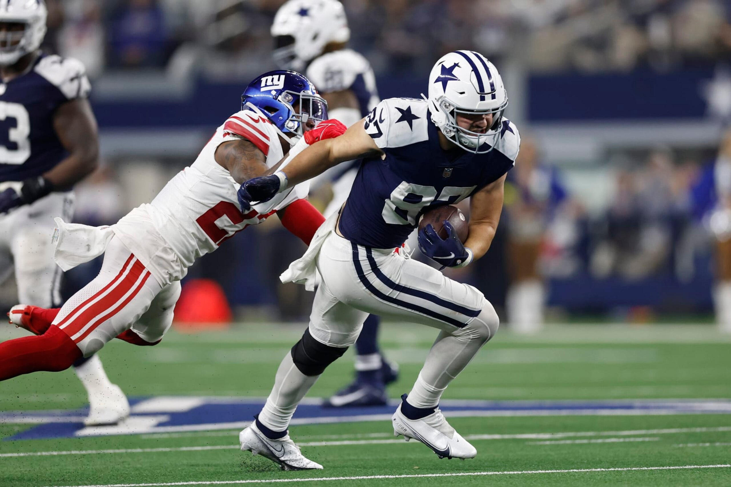 ARLINGTON, TEXAS - NOVEMBER 24: Jake Ferguson #87 of the Dallas Cowboys runs with the ball during the second half in the game against the New York Giants at AT&T Stadium on November 24, 2022 in Arlington, Texas. (Photo by Wesley Hitt/Getty Images) ARLINGTON, TEXAS - NOVEMBER 24: Jake Ferguson #87 of the Dallas Cowboys runs with the ball during the second half in the game against the New York Giants at AT&T Stadium on November 24, 2022 in Arlington, Texas. (Photo by Wesley Hitt/Getty Images)