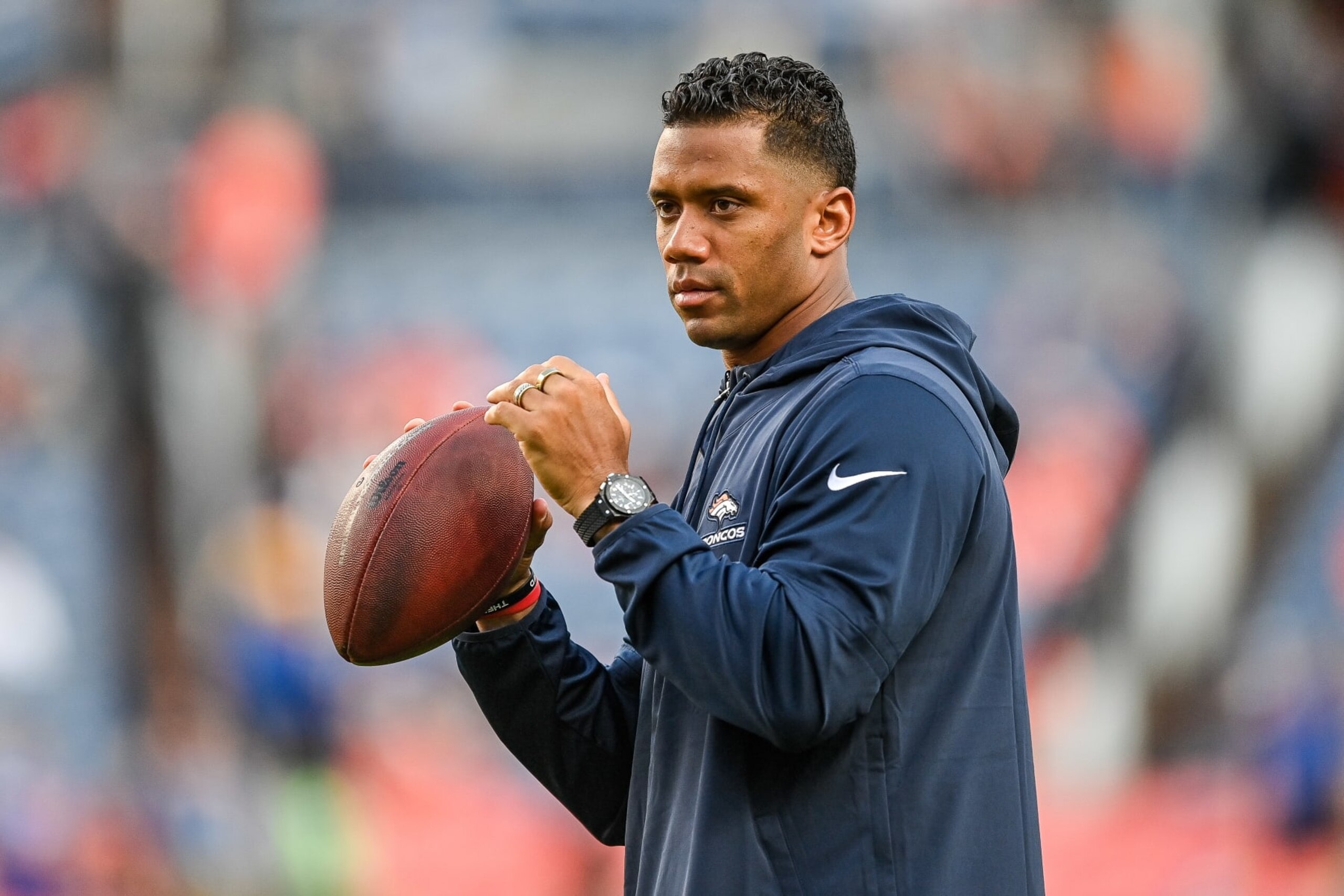 DENVER, COLORADO - AUGUST 26: Quarterback Russell Wilson of the Denver Broncos throws as players warm up before a game against the Los Angeles Rams at Empower Field at Mile High on August 26, 2023 in Denver, Colorado. (Photo by Dustin Bradford/Getty Images) DENVER, COLORADO - AUGUST 26: Quarterback Russell Wilson of the Denver Broncos throws as players warm up before a game against the Los Angeles Rams at Empower Field at Mile High on August 26, 2023 in Denver, Colorado. (Photo by Dustin Bradford/Getty Images)