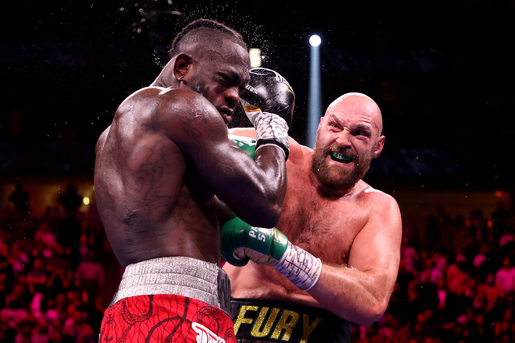 LAS VEGAS, NEVADA - OCTOBER 09: Tyson Fury (R) punches Deontay Wilder during their WBC heavyweight title fight at T-Mobile Arena on October 09, 2021 in Las Vegas, Nevada. (Photo by Al Bello/Getty Images)