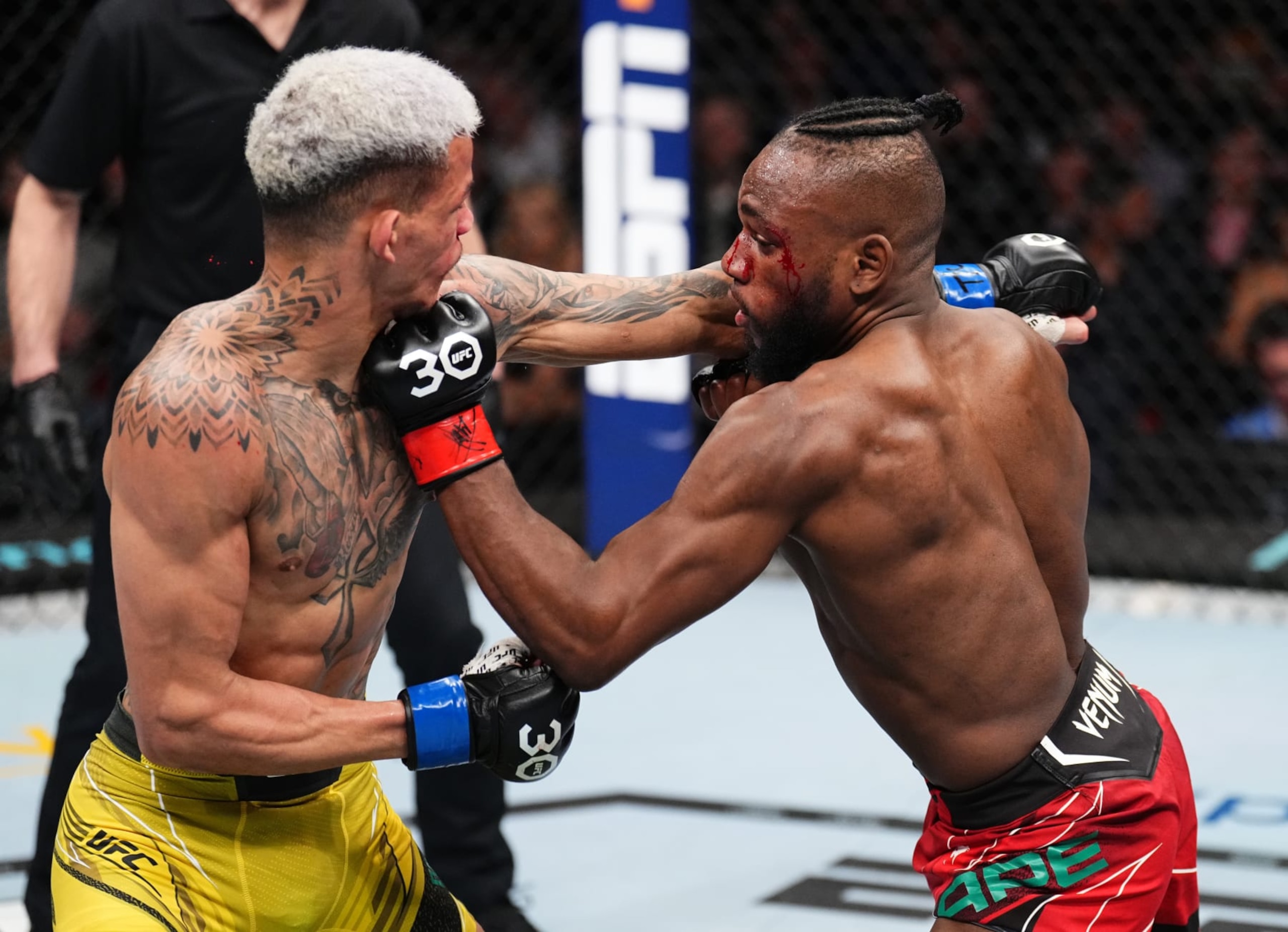 SYDNEY, AUSTRALIA - SEPTEMBER 10: (R-L) Manel Kape of Angola punches Felipe dos Santos of Brazil in a flyweight fight during the UFC 293 event at Qudos Bank Arena on September 10, 2023 in Sydney, Australia. (Photo by Chris Unger/Zuffa LLC via Getty Images)