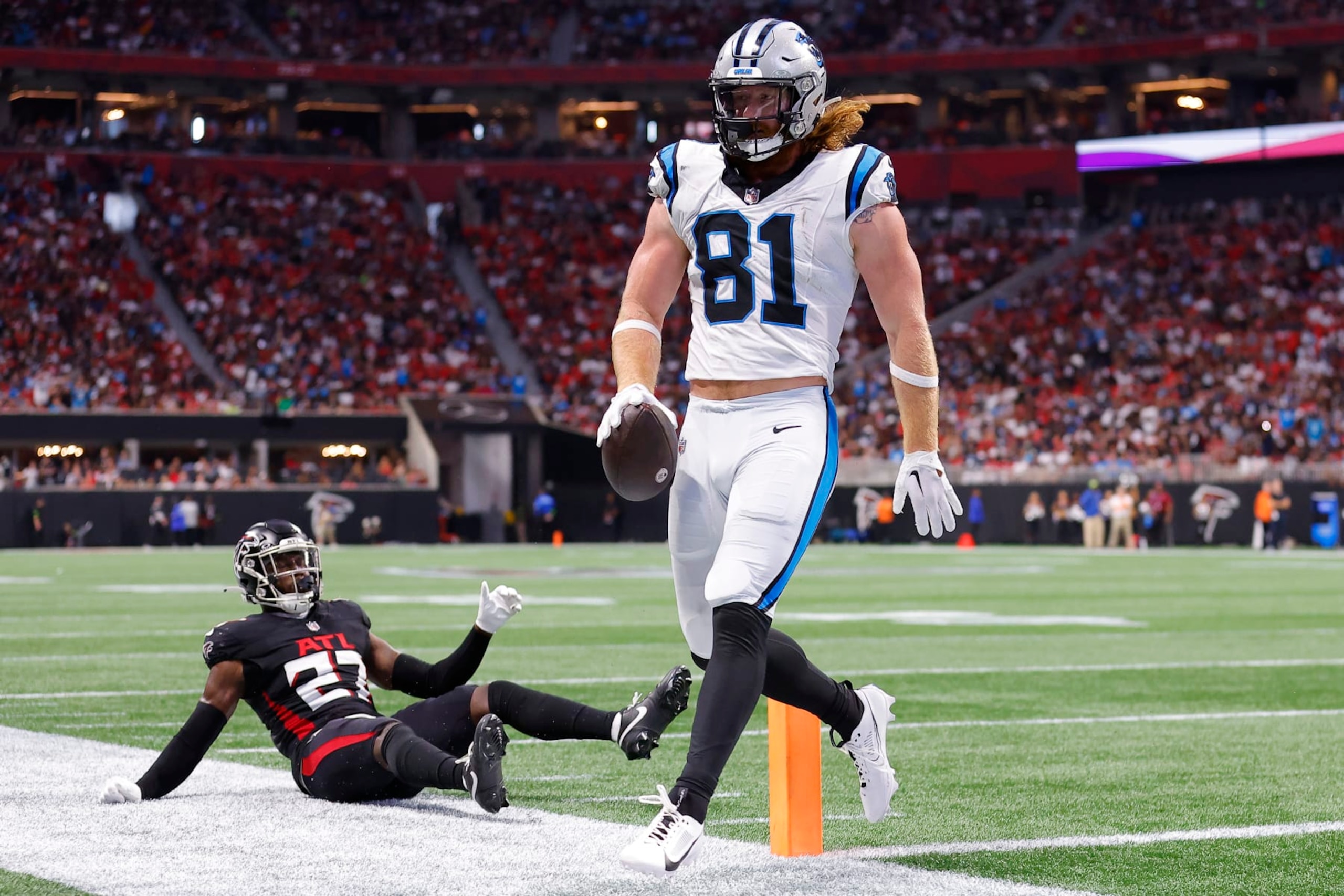 ATLANTA, GEORGIA - SEPTEMBER 10: Hayden Hurst #81 of the Carolina Panthers runs past Richie Grant #27 of the Atlanta Falcons while scoring a touchdown during the second quarter at Mercedes-Benz Stadium on September 10, 2023 in Atlanta, Georgia. (Photo by Todd Kirkland/Getty Images)