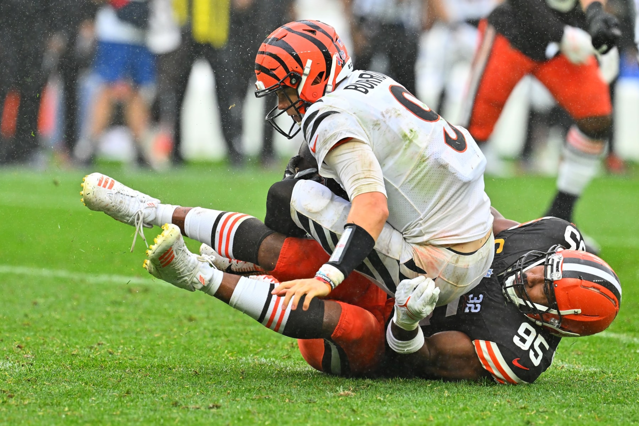 CLEVELAND, OHIO - SEPTEMBER 10:  Joe Burrow #9 of the Cincinnati Bengals is sacked by Myles Garrett #95 of the Cleveland Browns during the second half at Cleveland Browns Stadium on September 10, 2023 in Cleveland, Ohio. (Photo by Jason Miller/Getty Images)