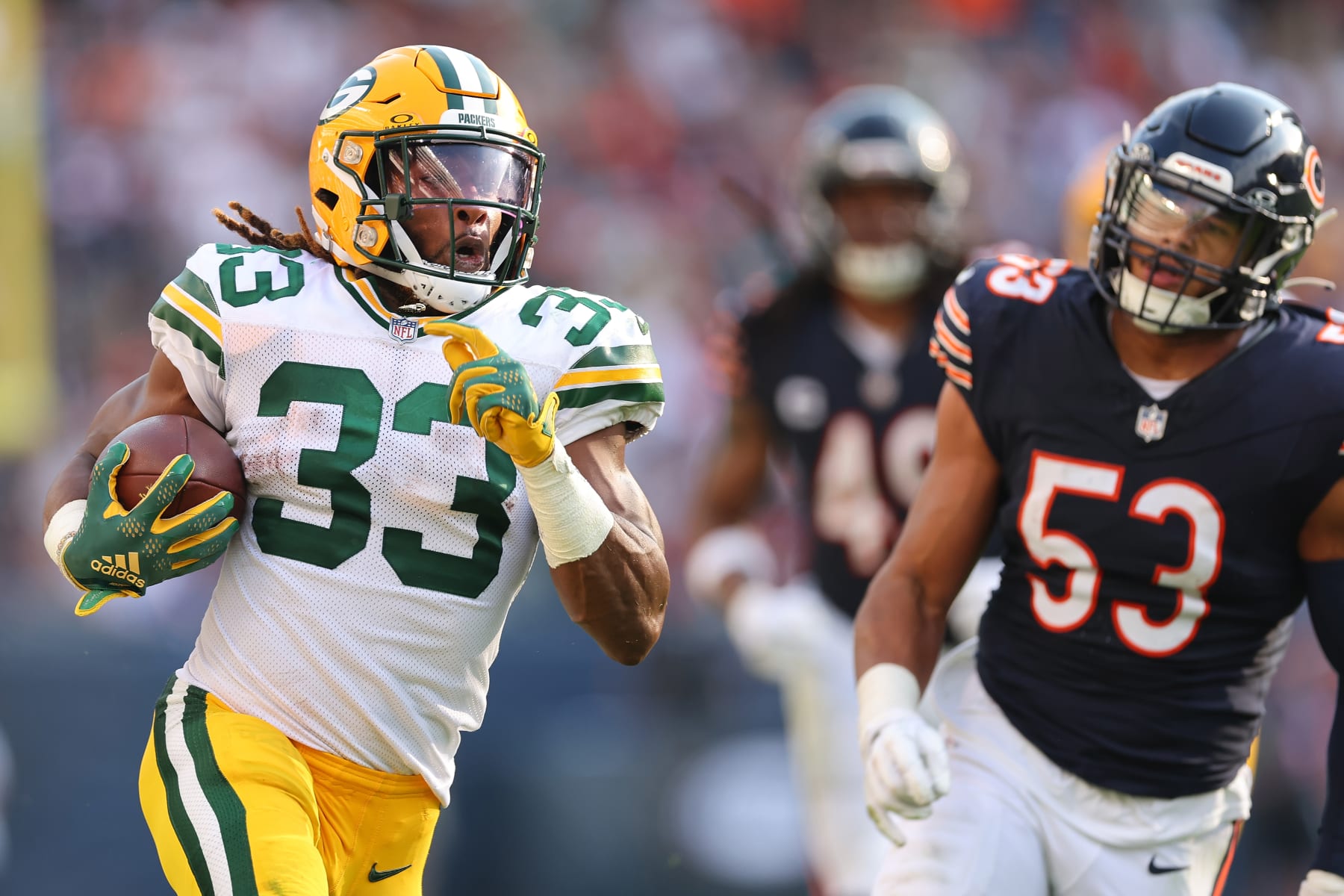 Aaron Jones runs past T.J. Edwards