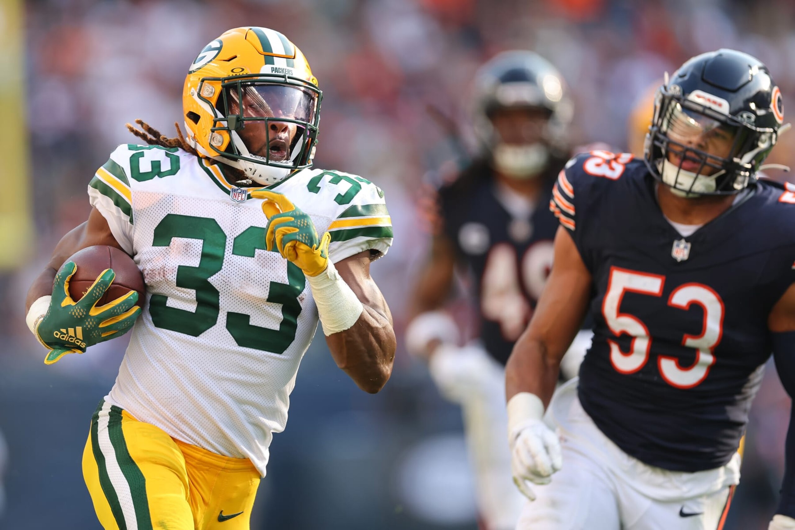 Aaron Jones runs past T.J. Edwards