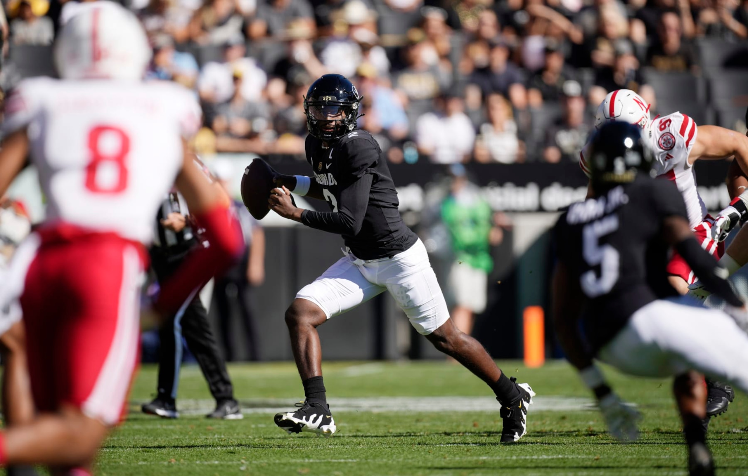 Colorado quarterback Shedeur Sanders (2) rolls out to pass in the first half of an NCAA college football game against Nebraska Saturday, Sept. 9, 2023, in Boulder, Colo. (AP Photo/David Zalubowski)